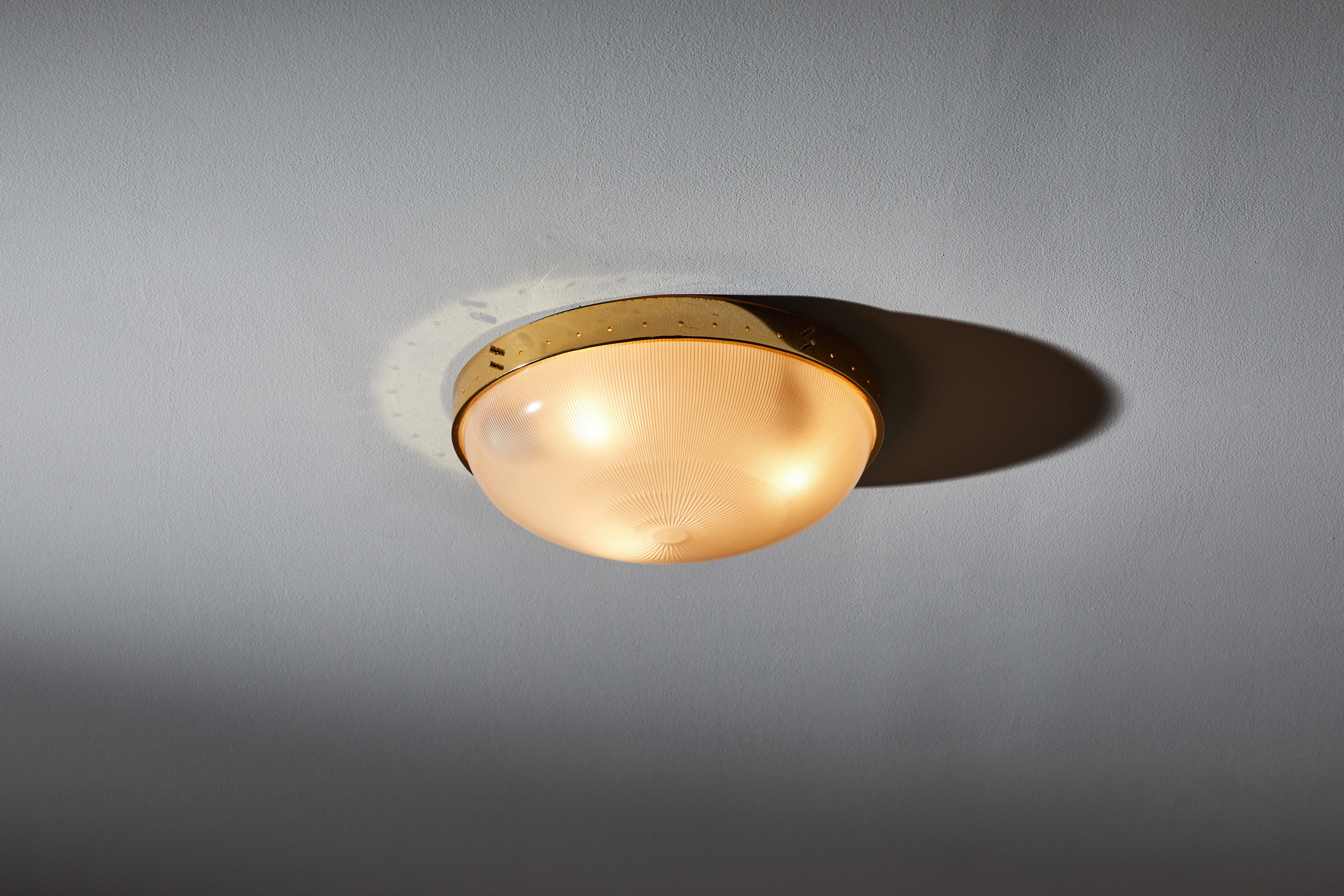 Four flush mount ceiling lights. Manufactured in Italy, circa 1960s. Holophane glass, brass. Rewired for U.S. standards. We recommend three E27 40w maximum bulbs. Bulbs provided as a one time courtesy. Priced and sold individually.