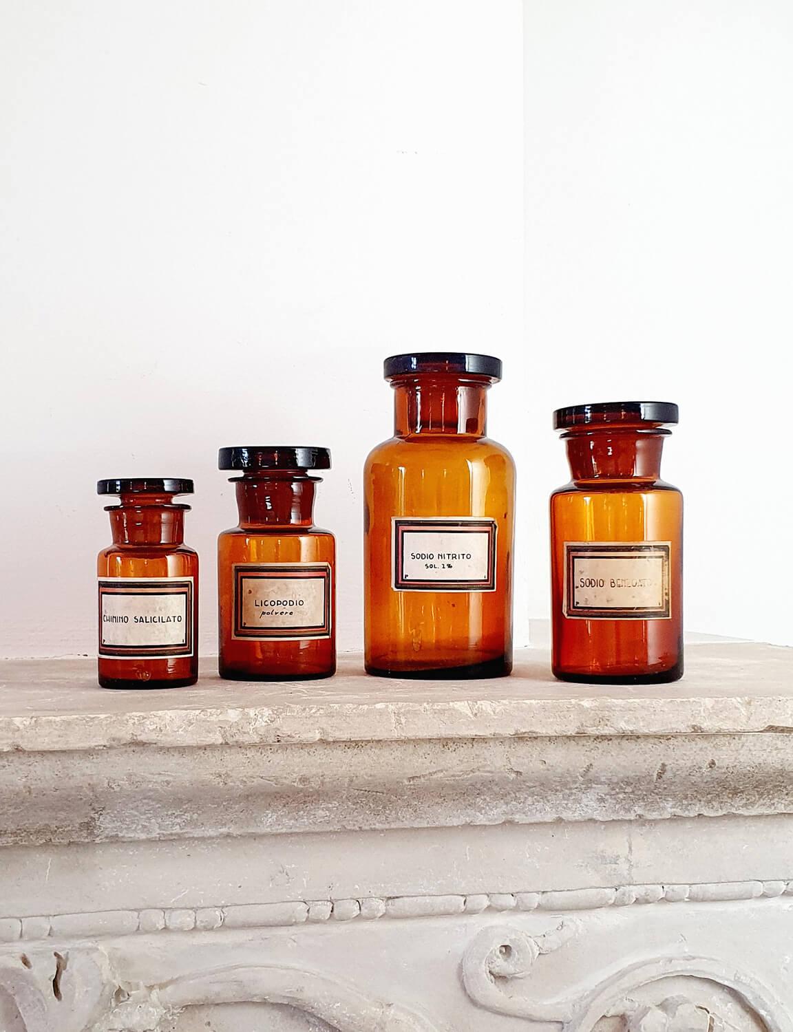 Four Italian medicine bottles found in Umbria from the early 1900s. Each bottle has a beautiful hand written label with Italian medicines. All are in good condition each with glass caps. 

Dimensions: Bottle 1: H20cm XW9cm X D9cm Bottle 2: H16cm X
