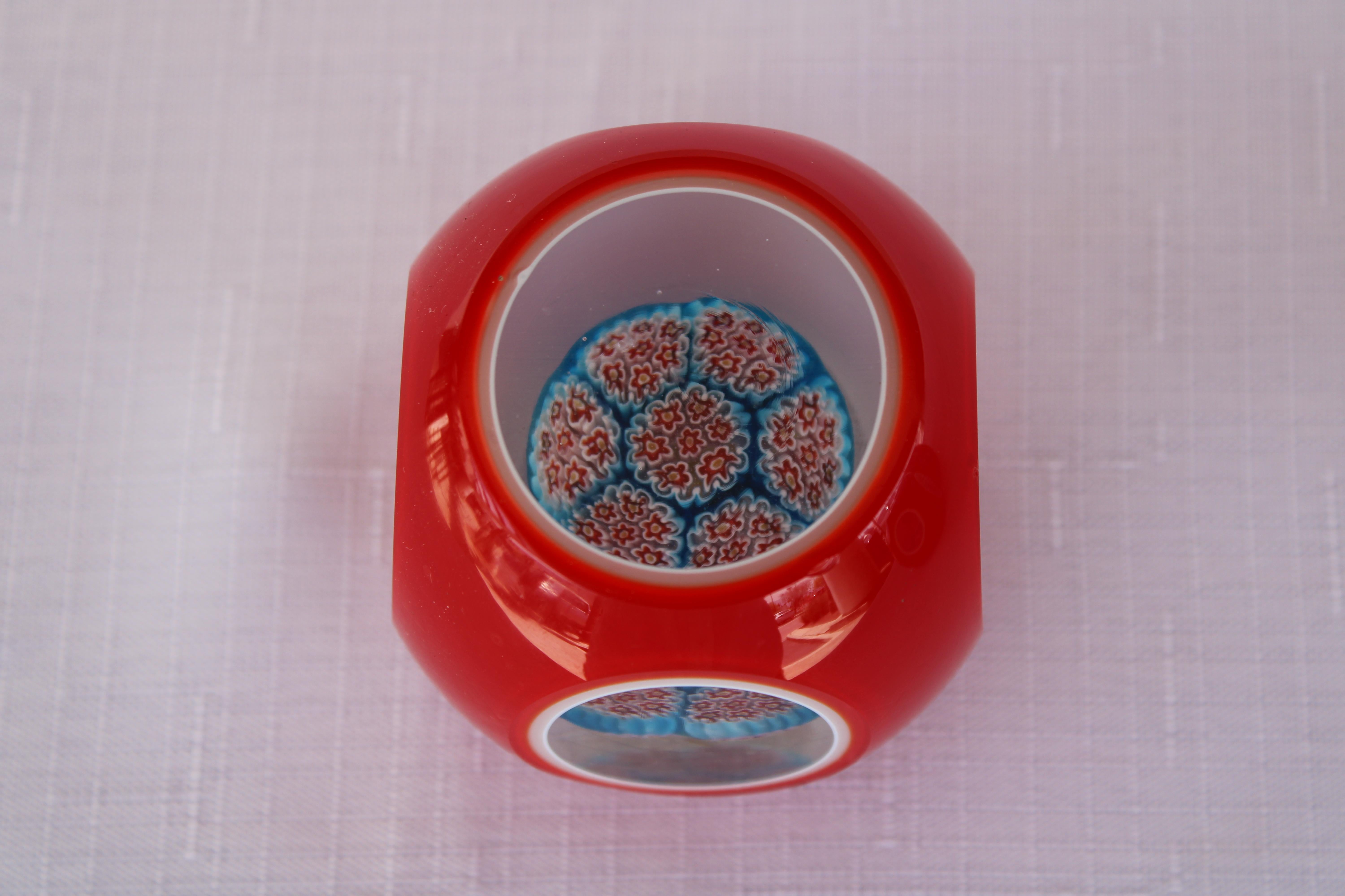 Four Italian Murano red millefiori cased glass paperweights. From left to right they measure 1.) 2.75