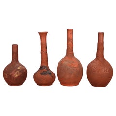 Four Japanese Embossed Terra Cotta Long Neck Vases C1930