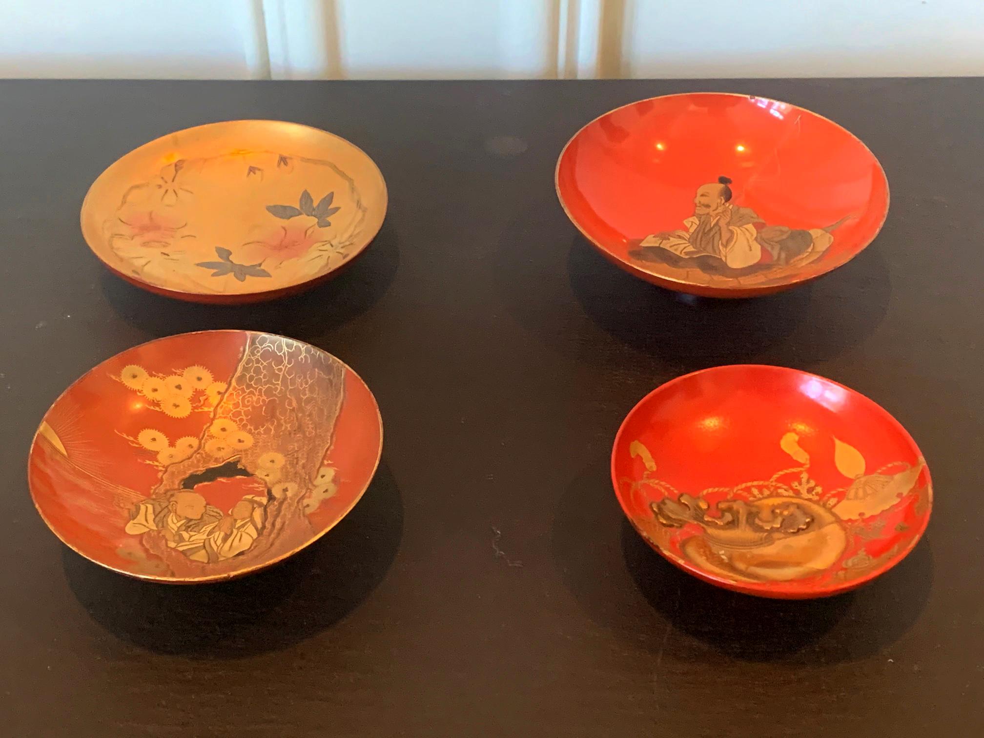 An assemble of four lacquerware sake cups from Meiji period Japan circa late 19th century. The shadow cups on an elevated stem were used by the nobles during to drink sake at feast. Each with individual Maki-e design; some with high relief