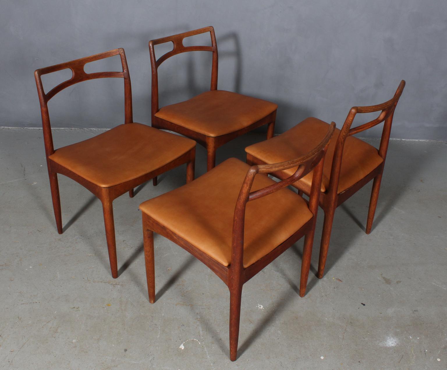 Four beautiful Johannes Andersen dining chairs with solid teak frame.

New upholstered with cognac aniline leather.

Model 96, made by Christian Linneberg.
 