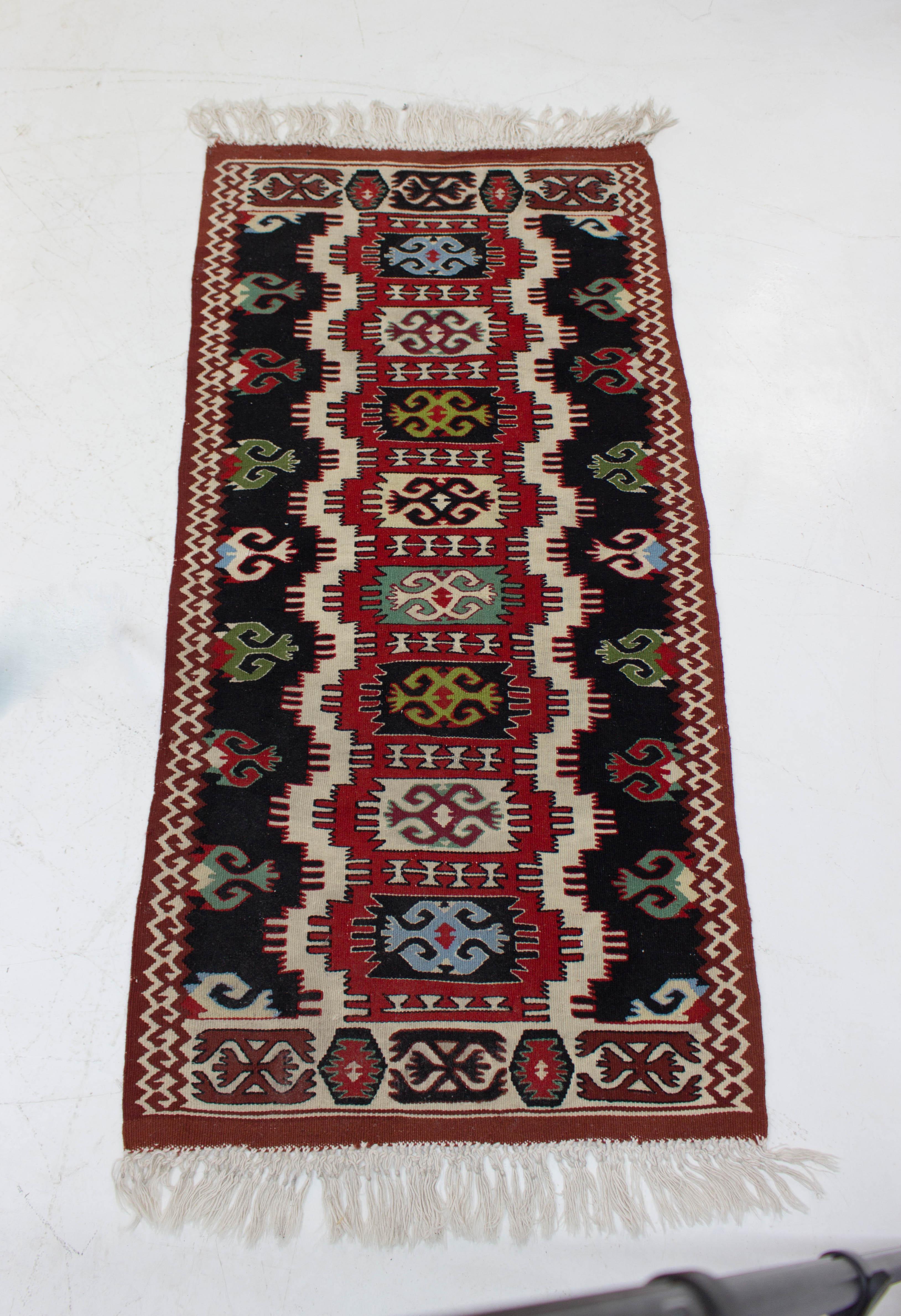 A set of four wool Kilim rugs produced in Czechoslovakia in 1960s. They are in a good original condition. One has minor fading in the center. Two pieces: 127 cm x 58 cm, two pieces: 146 cm x 66 cm.