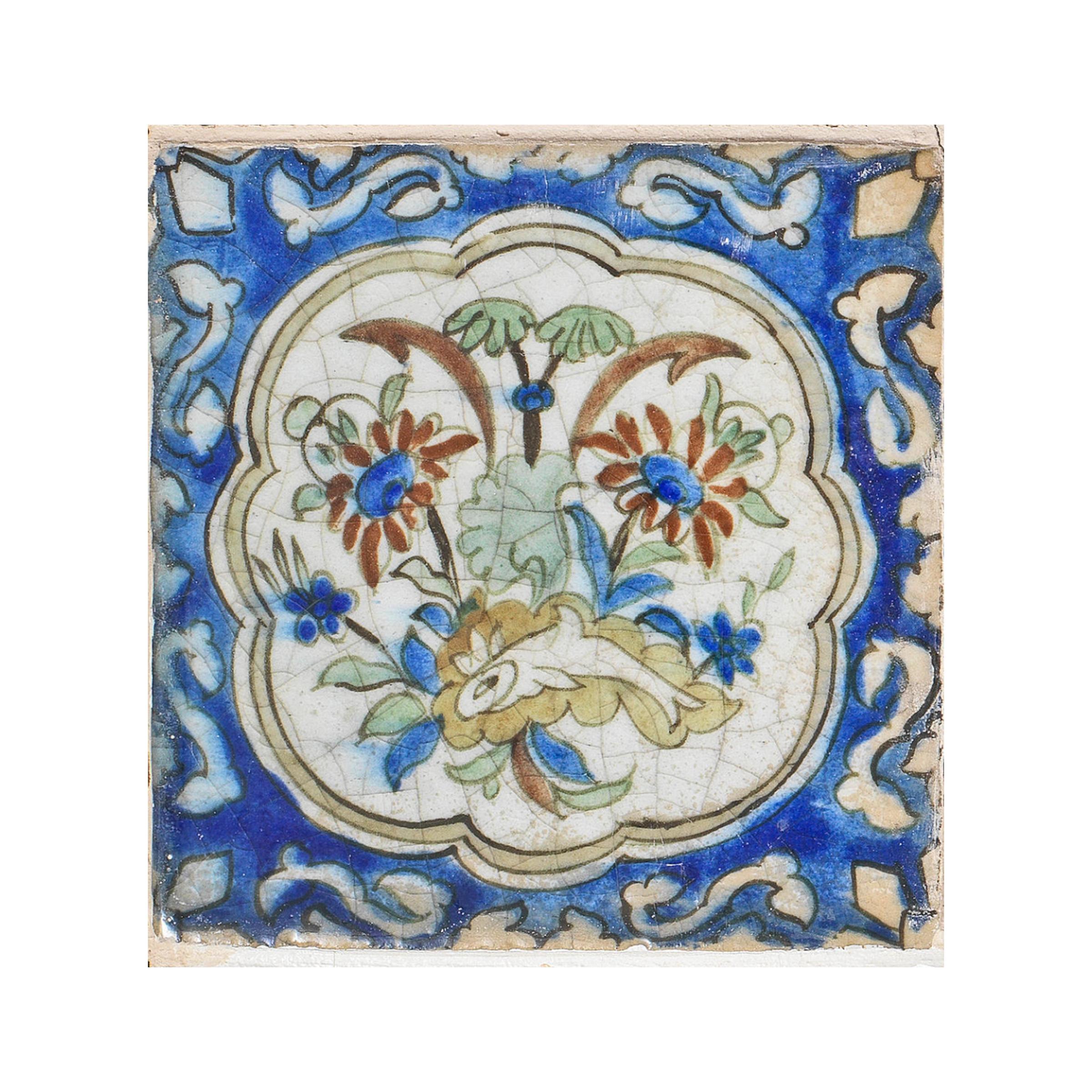 Each tile of square form and decorated in cobalt blue, green, red, mustard yellow and manganese on a white ground with lobed cartouches filled with varied floral motifs and surrounded by scrolling vines, framed.
   