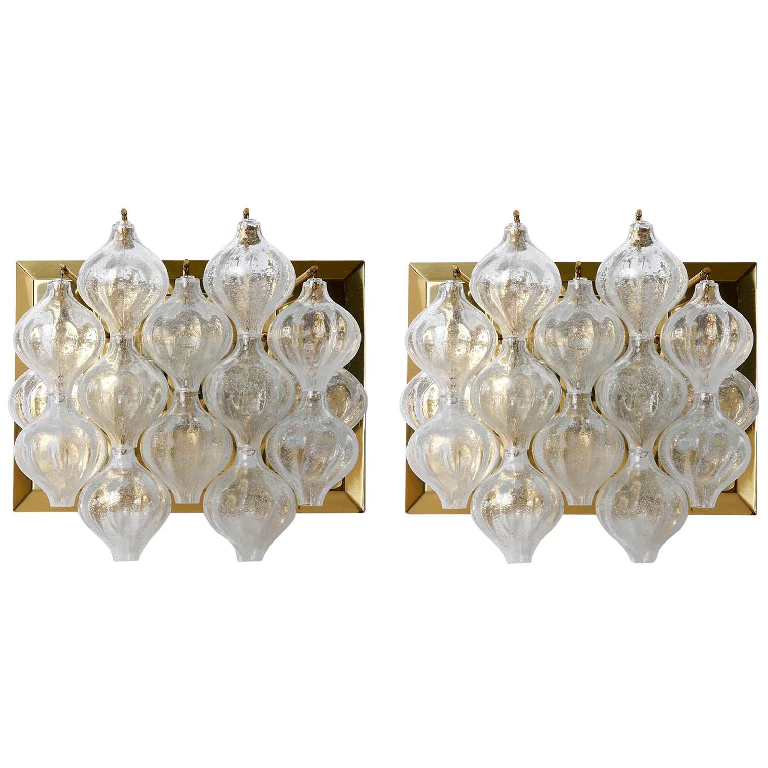 One of four large 'Tulipan' brass and glass wall light fixtures by J.T. Kalmar, Austria, Vienna, manufactured in midcentury, circa 1970 (late 1960s or early 1970s).
The name Tulipan derives from the tulip shaped hand blown bubble glasses. Each glass