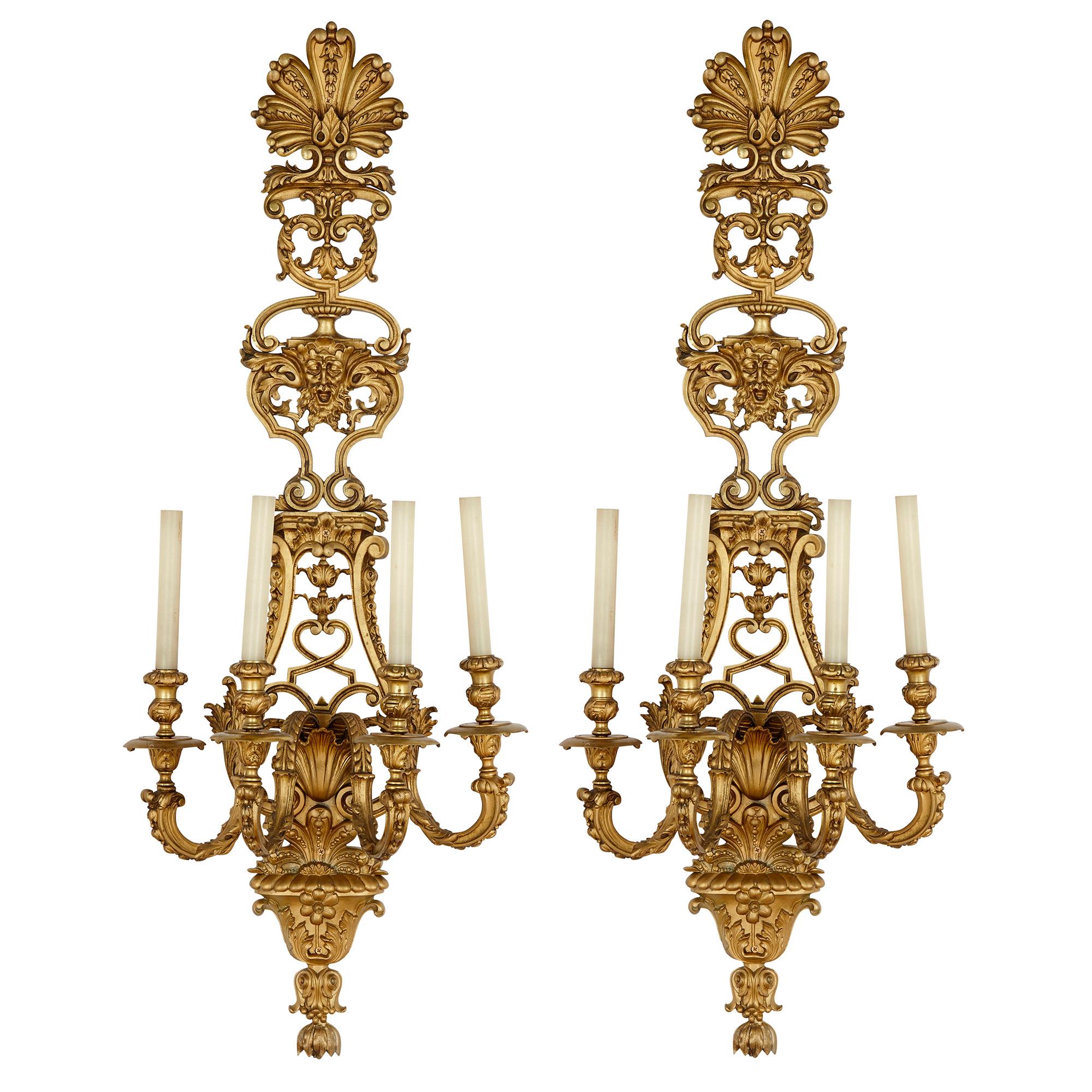 The gilt bronze sconces in this set of four are designed in the beautiful Regency style, the manner of decorative art that most closely aligns with the early Rococo yet betrays the lingering influence of Louis XIV. Each sconce features a shaped and
