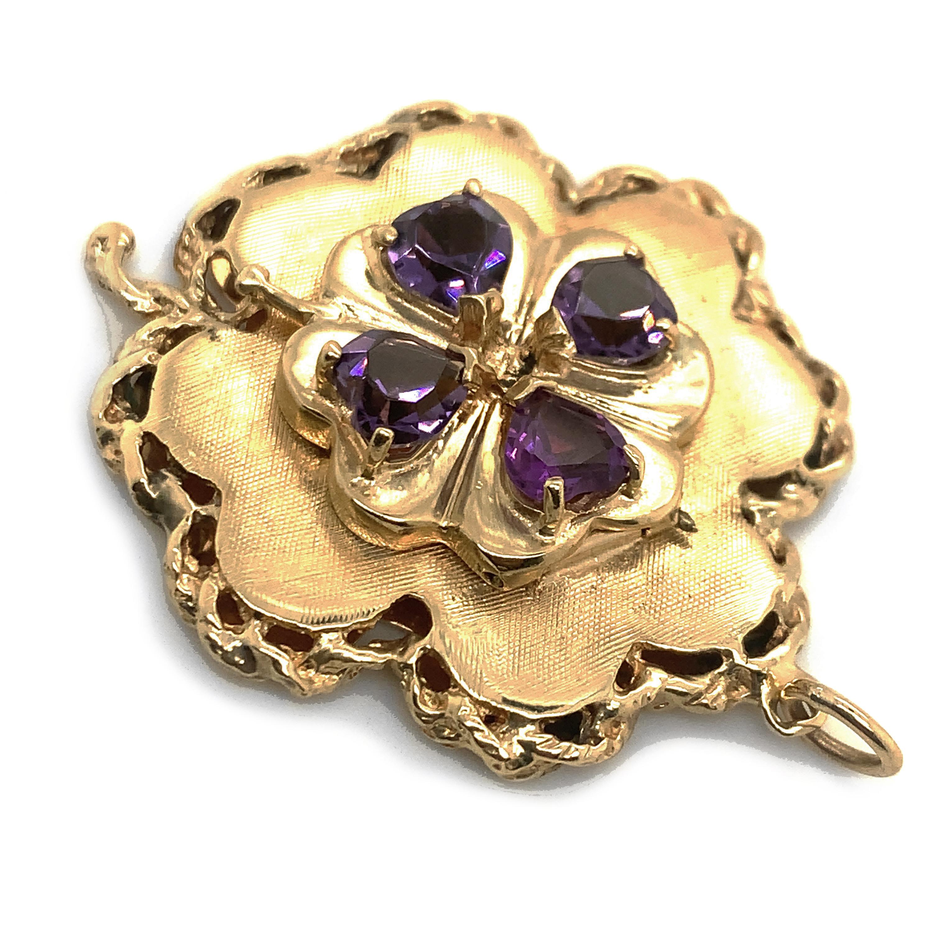 Striking large four leaf clover pendant/charm.  Four heart-shaped sparkling purple amethysts create a quatrefoil that beautifully join the themes of luck and love. This pendant is framed with a textured rope that highlight the retro craftsmanship to