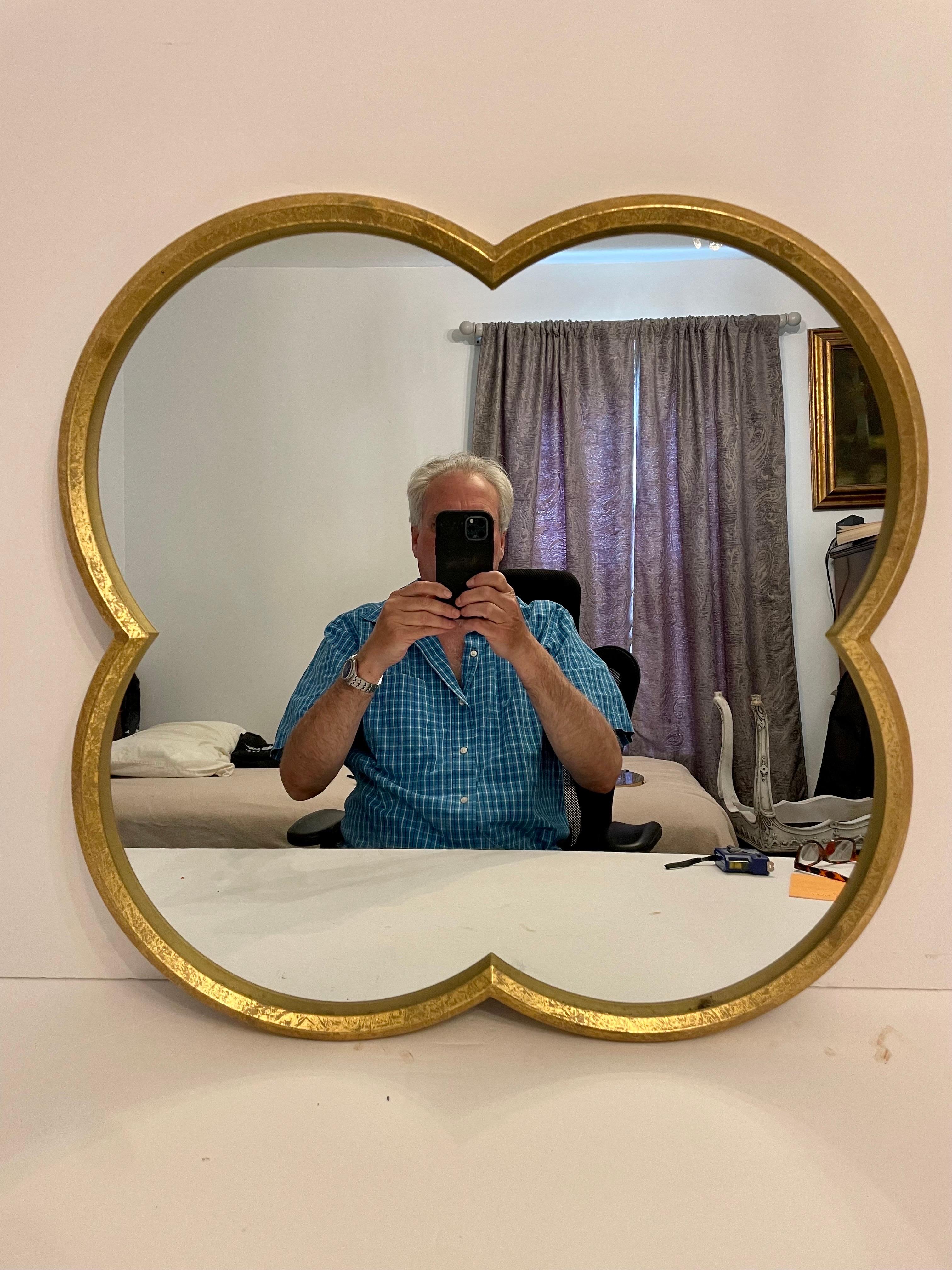 Miroir en fer doré en forme de trèfle à quatre feuilles rappelant Van Cleef & Arpels. Pièces de la collection Alhambra. Bon état général. Peut être suspendu de deux façons comme indiqué sur les photos. 27