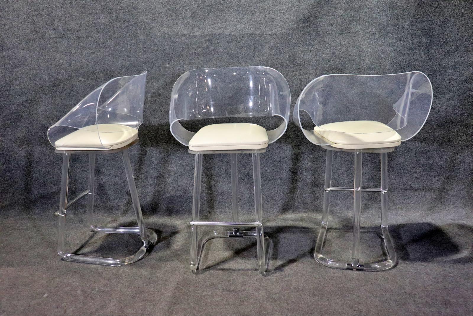 Four mid-century modern counter stools with lucite frame and clear bent backs.
Please confirm location NY or NJ