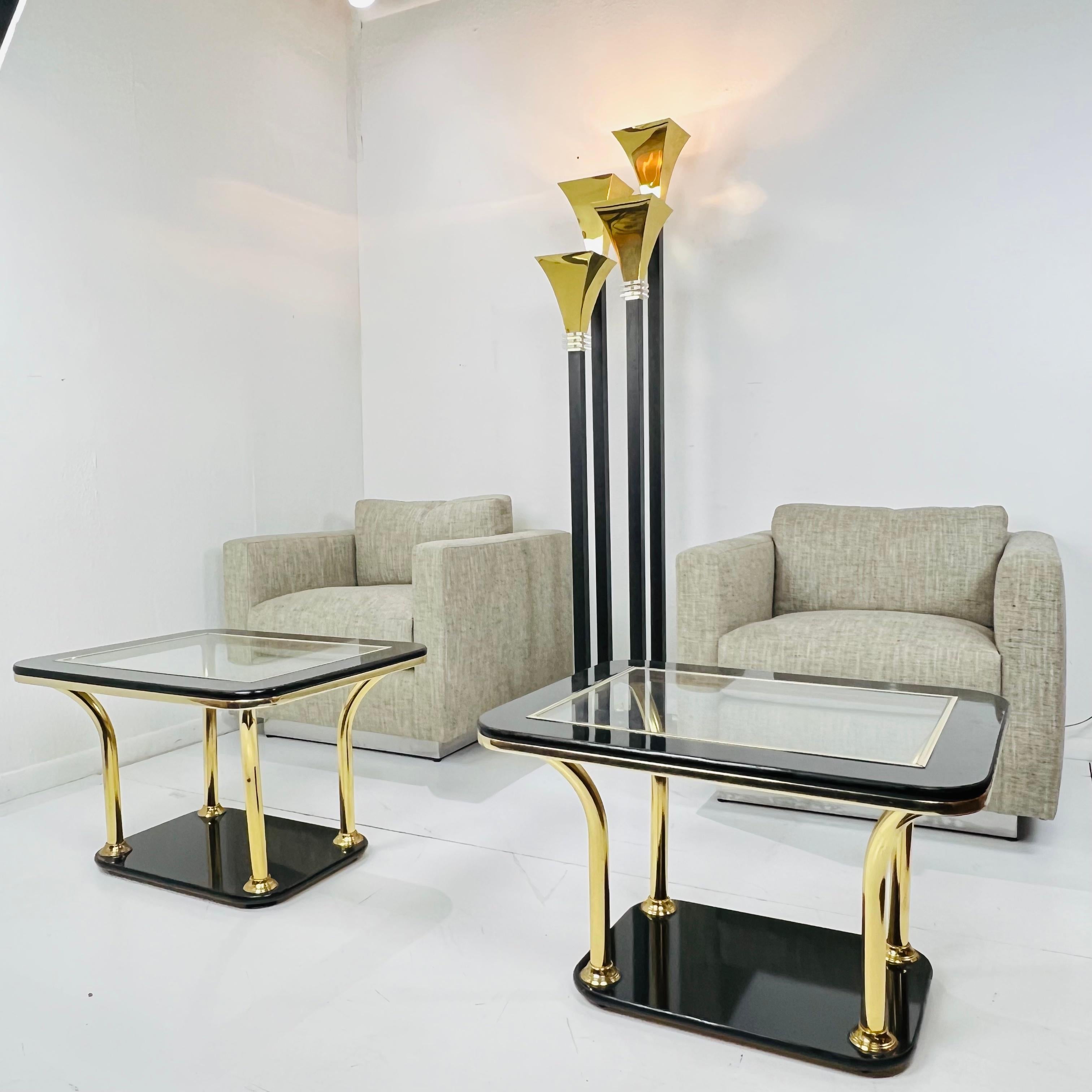Large art deco torchiere floor lamp featuring 4 ebonized metal pedestals with brass flared up-shades and lucite accents. Mounted on stepped base with footswitch. Good vintage condition with normal wear from age and use, plus some