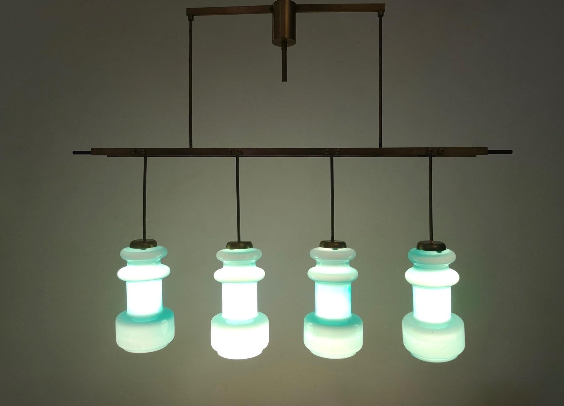 This chandelier is made in brass, varnished metal and cased and molded blown glass. 
It is a vintage item, therefore it might show slight traces of use, but it is in excellent original condition and ready to give ambiance to any room.

Measures: