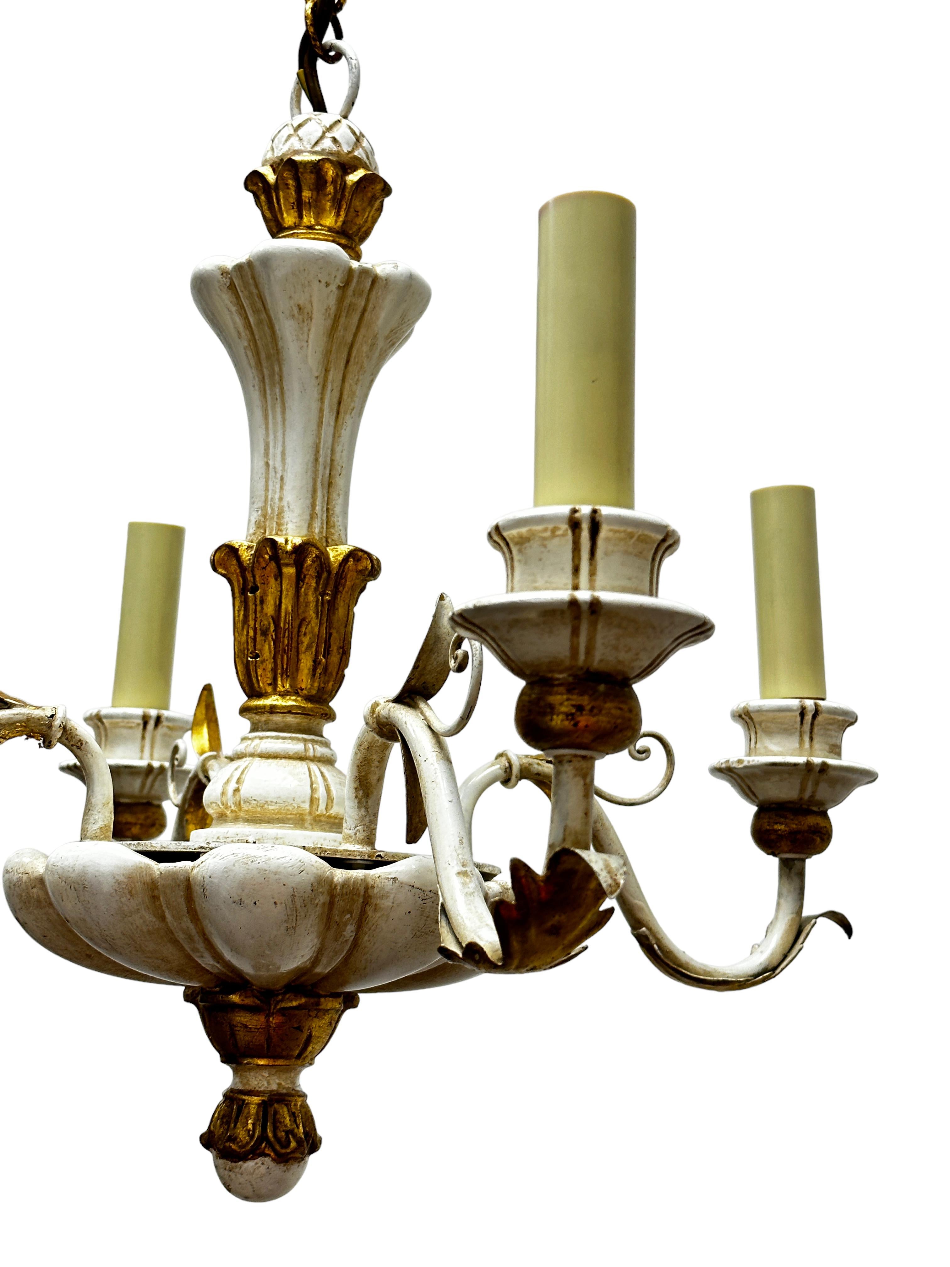 Add a touch of opulence to your home with this charming chandelier! Perfect chippy white, gilt wood and hand carved chandelier to enhance any chic or eclectic home. We'd love to see it hanging at a dinning place as a charming welcome. The chain with