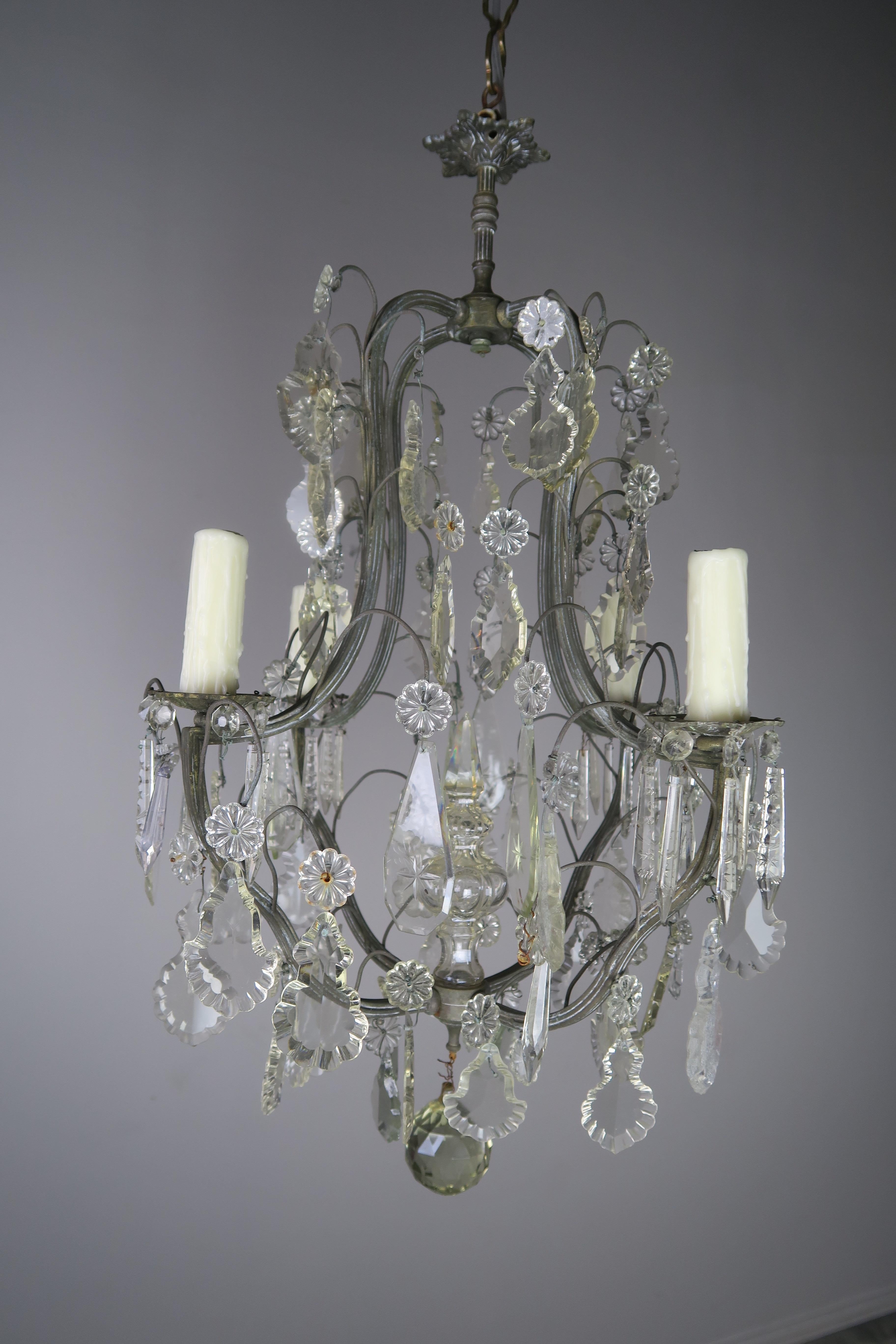 Italian four-light pewter finished metal chandelier adorned with various crystals including etched crystals with a star pattern. The chandelier is newly rewired with cream colored drip wax candle covers. The fixture includes chain and canopy and is