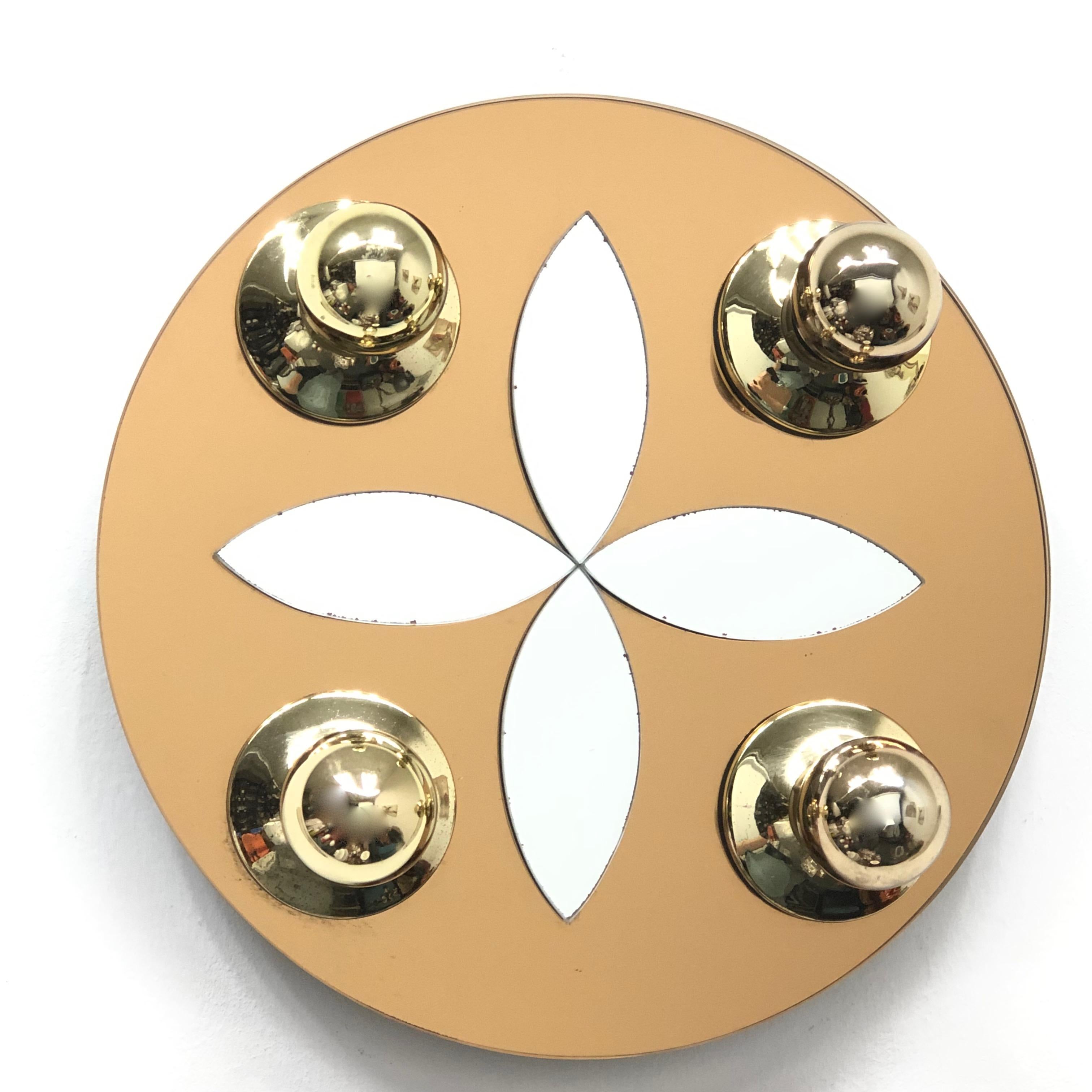 Elegant Austrian modern wall light, with brass base on a mirror and mounted on white lacquered metal. Manufactured by Eglo Leuchten in the 1980s. This fixture requires four European E14 lightbulbs, up to 40 watts each. Lightbulbs pictured are not