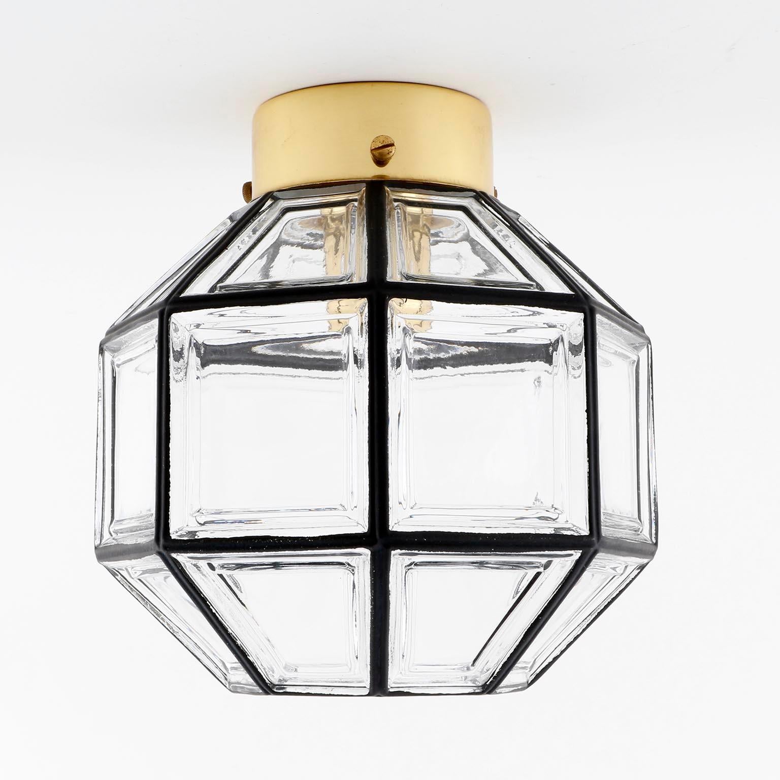 One of three beautiful and unique design 'iron' glass lights by Glashütte Limburg, Germany, manufactured in midcentury, circa 1970 (late 1960s or early 1970s).
It can be used as wall or ceiling lamp. Black iron circles inlaid in thick clear glass.