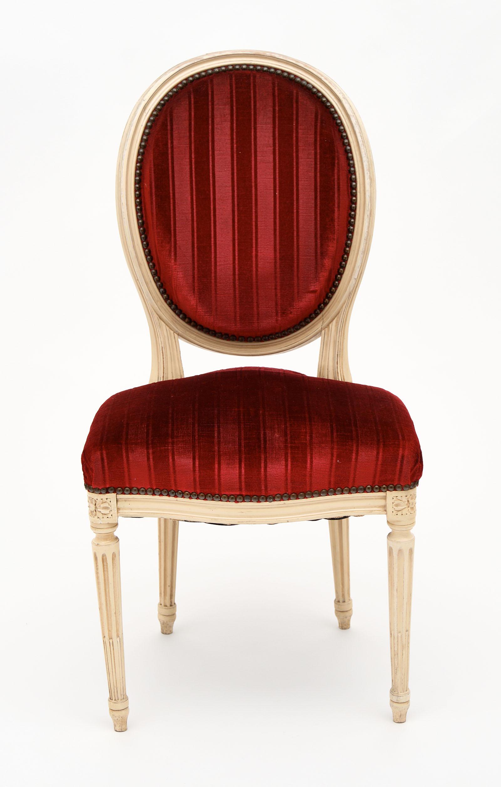 Four Louis XVI style French chairs with the original velvet striped upholstery. We love the hand painted beechwood frames and the good condition of the fabric.