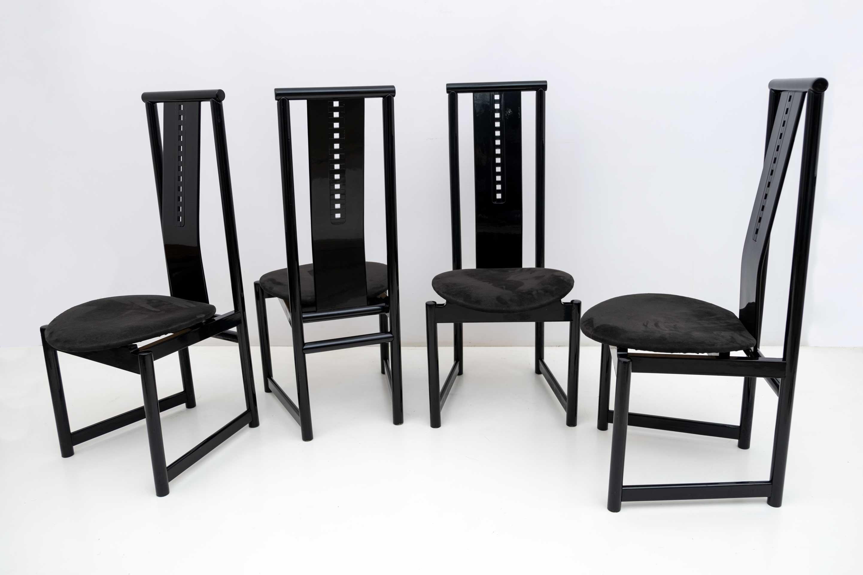 In the style of Scottish architect Charles Rennie Mackintosh. These four chairs, solidly built in black lacquered wood, with black Alcantara upholstery, late 1970s.