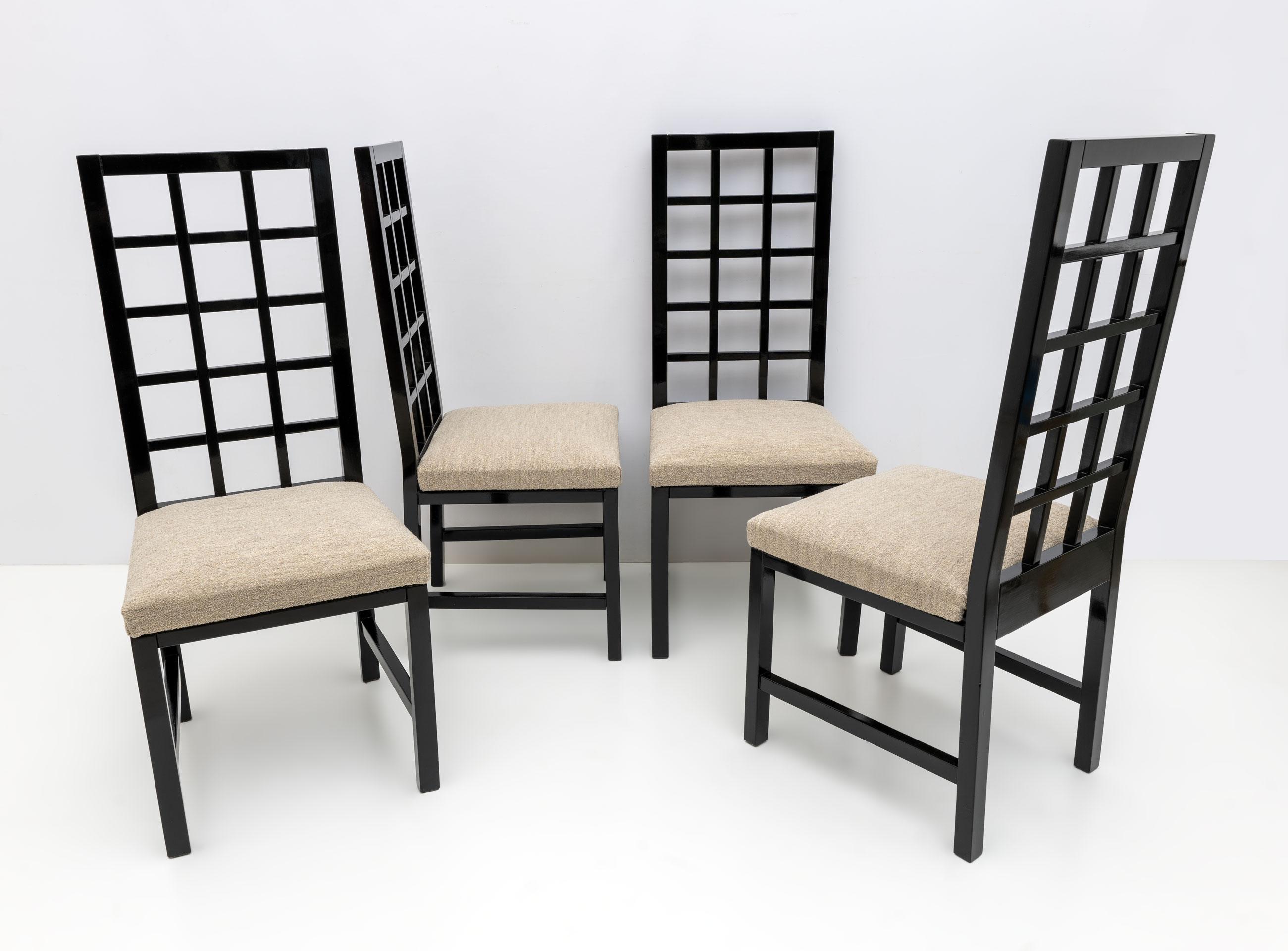 In the style of Scottish architect Charles Rennie Mackintosh. These four chairs, solidly built in black lacquered wood, with ivory bouclé upholstery, late 1970s.
