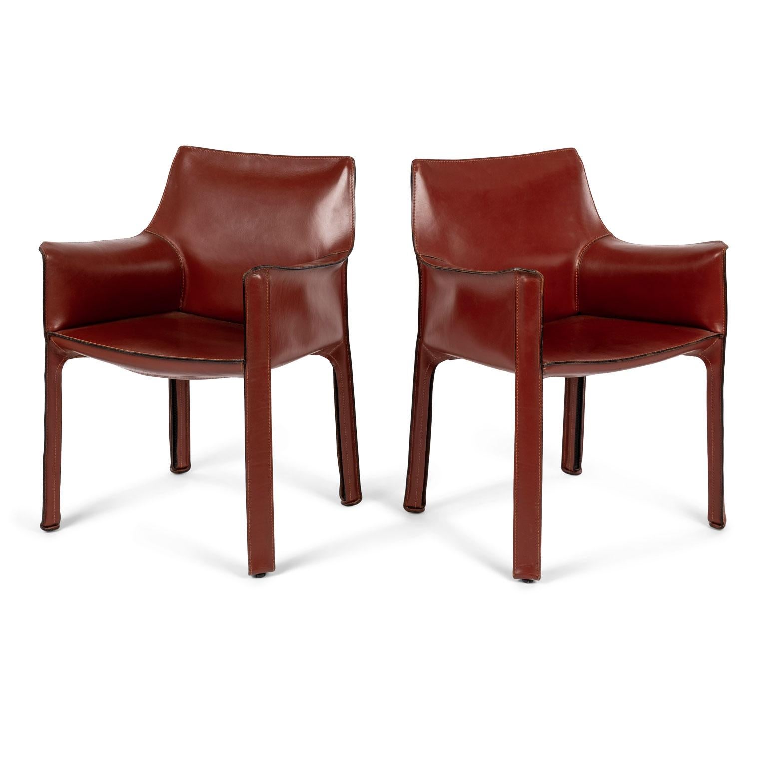Four Mario Bellini Cab 413 armchairs in Rosso Cina finish, fabricated by Cassina in the 1980s. Flexible steel frame covered with a skin of high quality saddle leather. This elegant, versatile chair is equally suitable for the dining room, study or