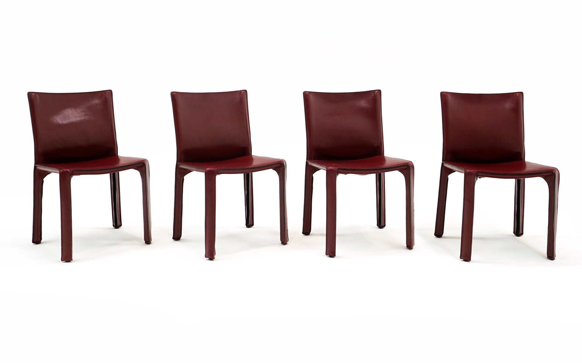Early set of 4 CAB Chairs designed by Mario Bellini for Cassina, 1970s.  Burgundy / deep red / oxblood leather.  Some wear to edges, but overall very good condition.  These have been in the same seldom used residence since they were new in the late