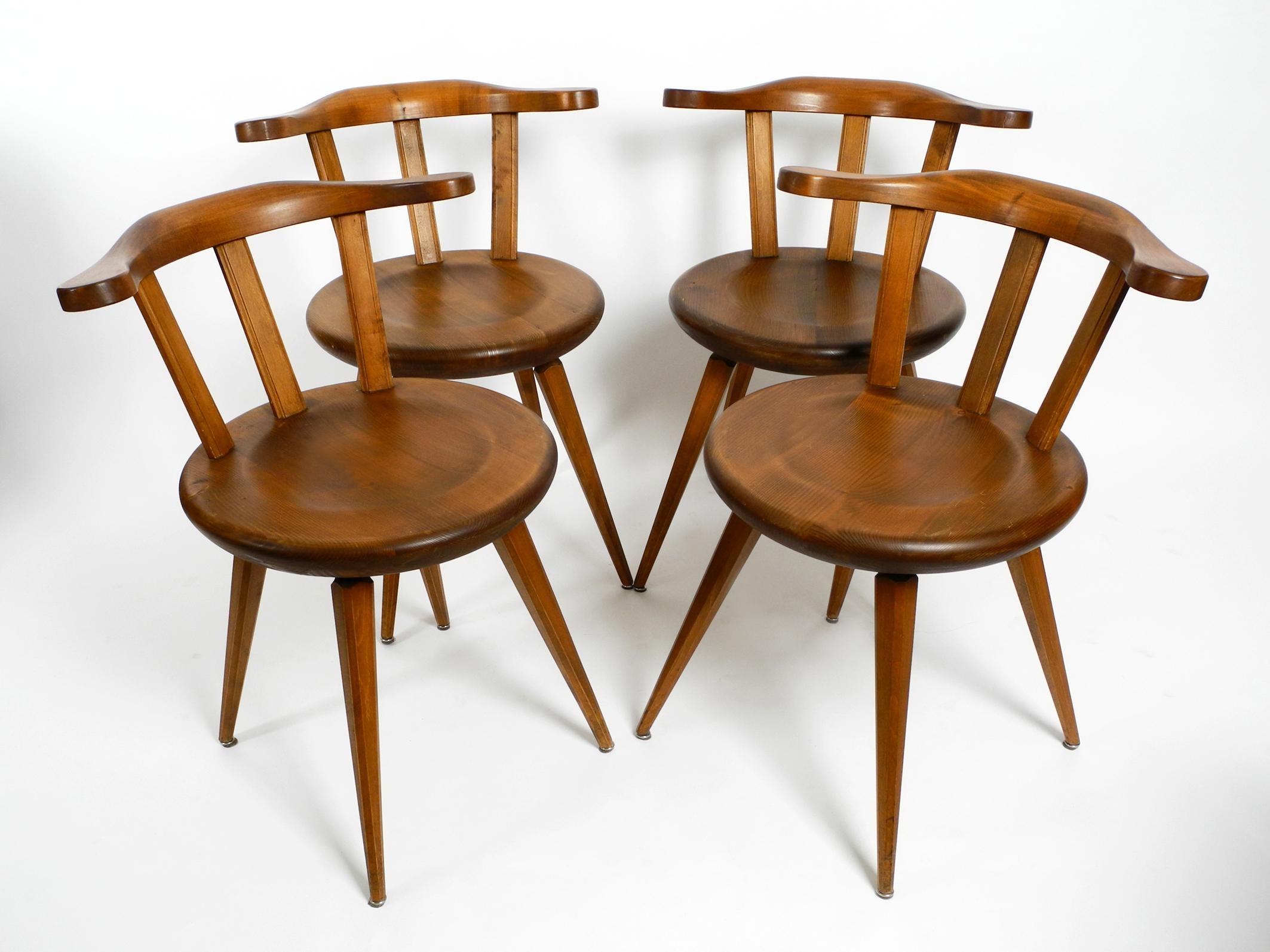 Four massive, beautiful mid-century solid wood chairs with low backs. 
Great Minimalist design. Made in Germany.
Frame made of dark stained solid oak.
In very good original condition with no damage to the frame or seat.
All legs are firm and not