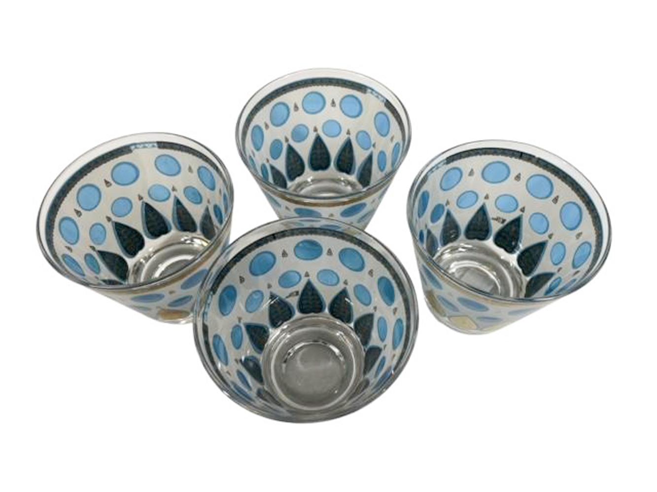 Set of four Cera Glassware old fashioned glasses with a double row of translucent blue dots on a white ground above a gold palmettes.