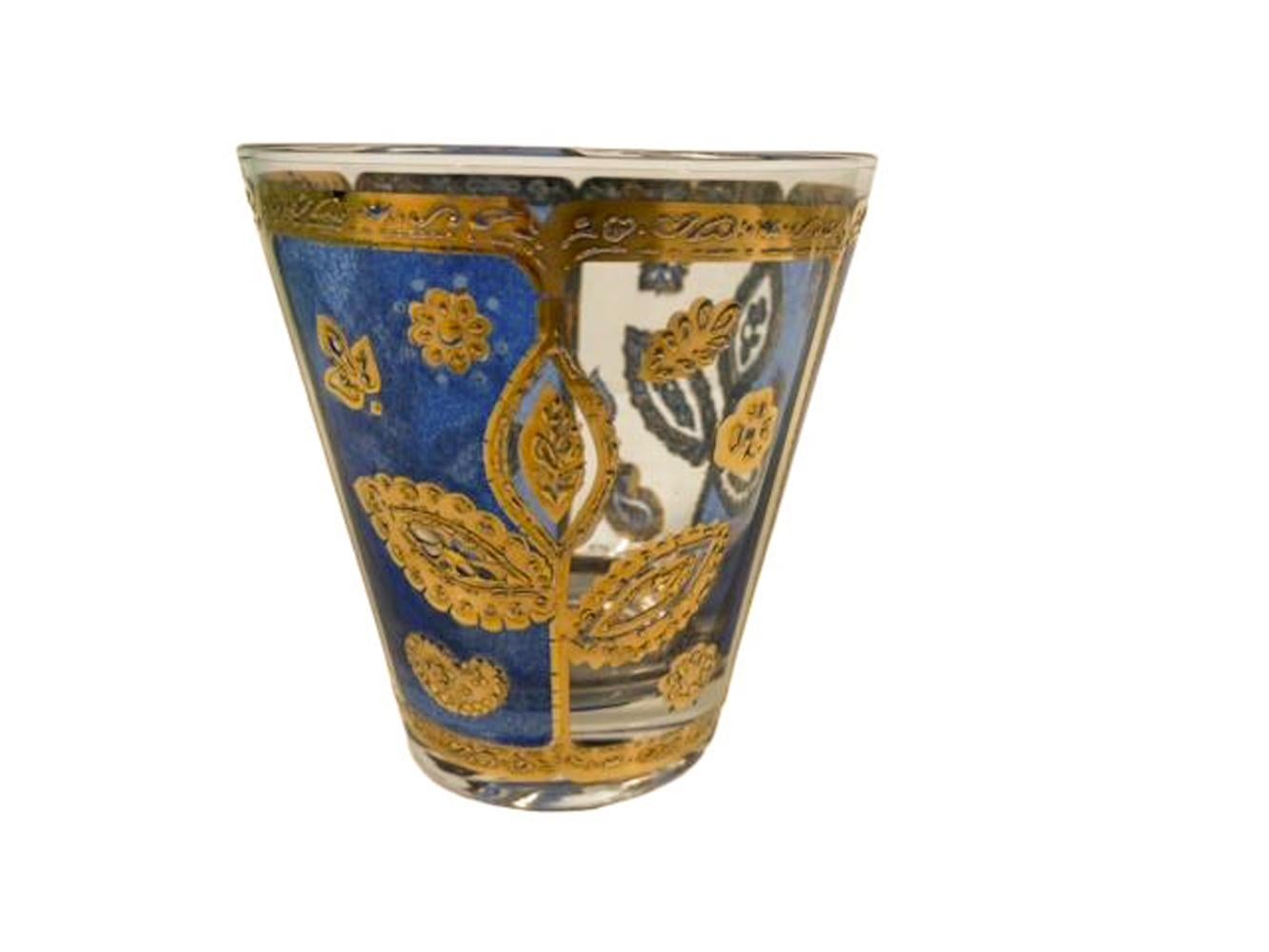 Set of four Culver LTD, double old fashioned glasses with a translucent blue enamel and 22 karat gold floral motif.