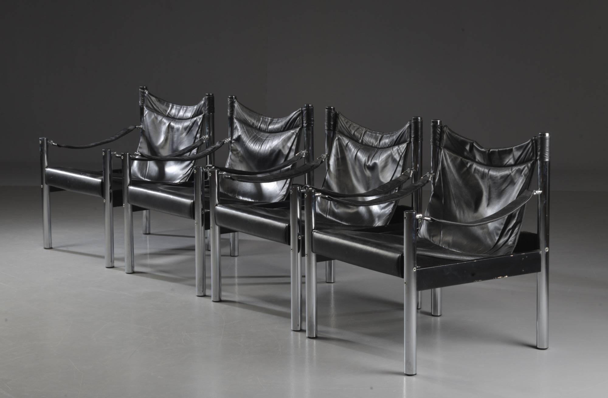Set of four Safari chairs with chrome steel frame. Seat and back of black leather and black lacquered wood. Released from Olsson furniture.