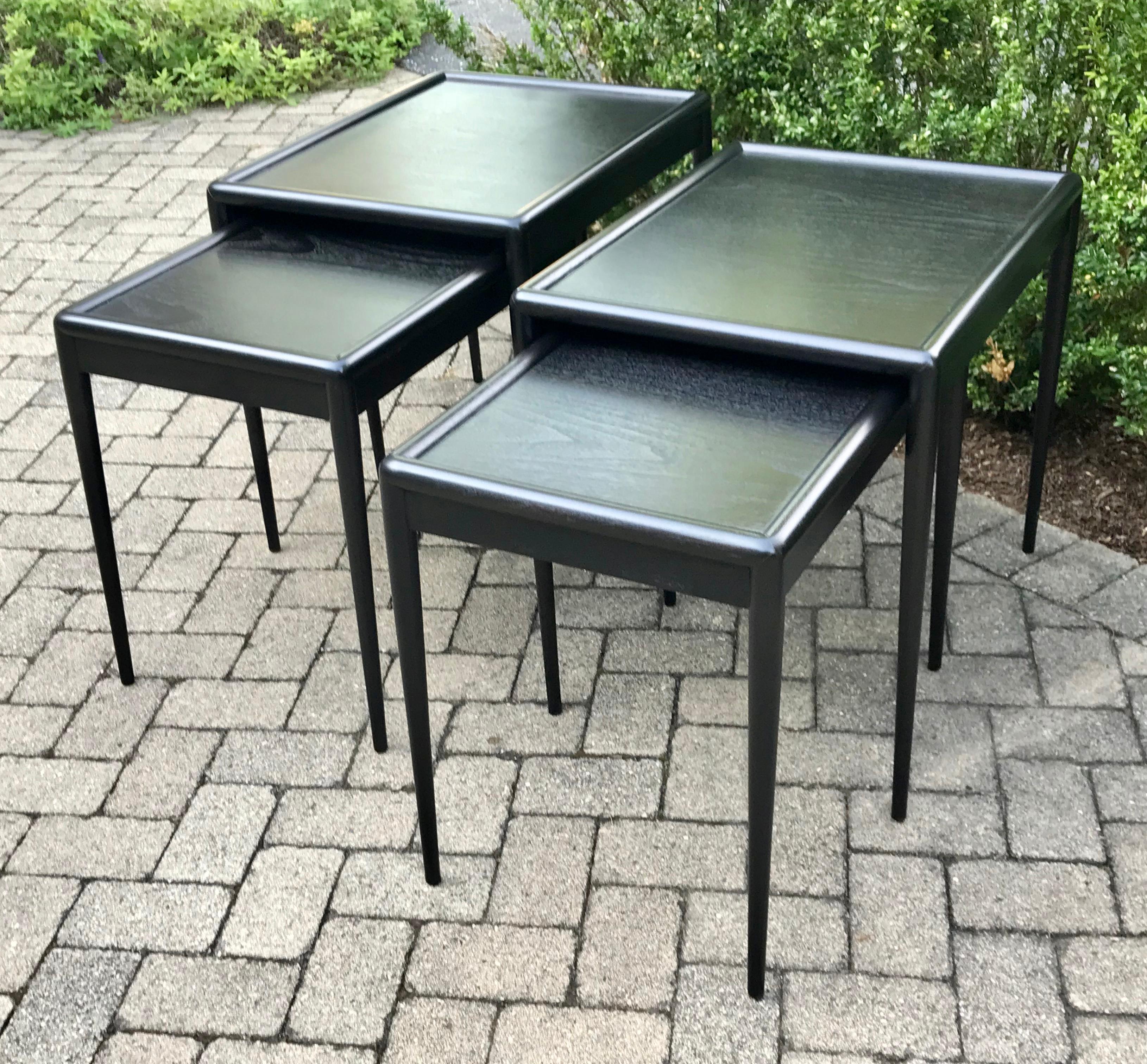 Beautiful pair of black nesting tables by T.H. Robsjohn-Gibbings for Widdicomb. There tables are walnut but were recently professionally sprayed semi gloss black.

British-born designer, interior decorator and author T.H. Robsjohn-Gibbings (1905–76)
