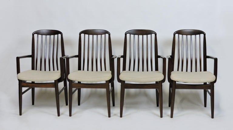 Set of four BL10A Sanne armchairs designed by Danish designer Benny Linden. These chairs are made of solid walnut with contoured spindle backs and upholstered seats in the original oatmeal colored fabric. Very comfortable chairs with a graceful