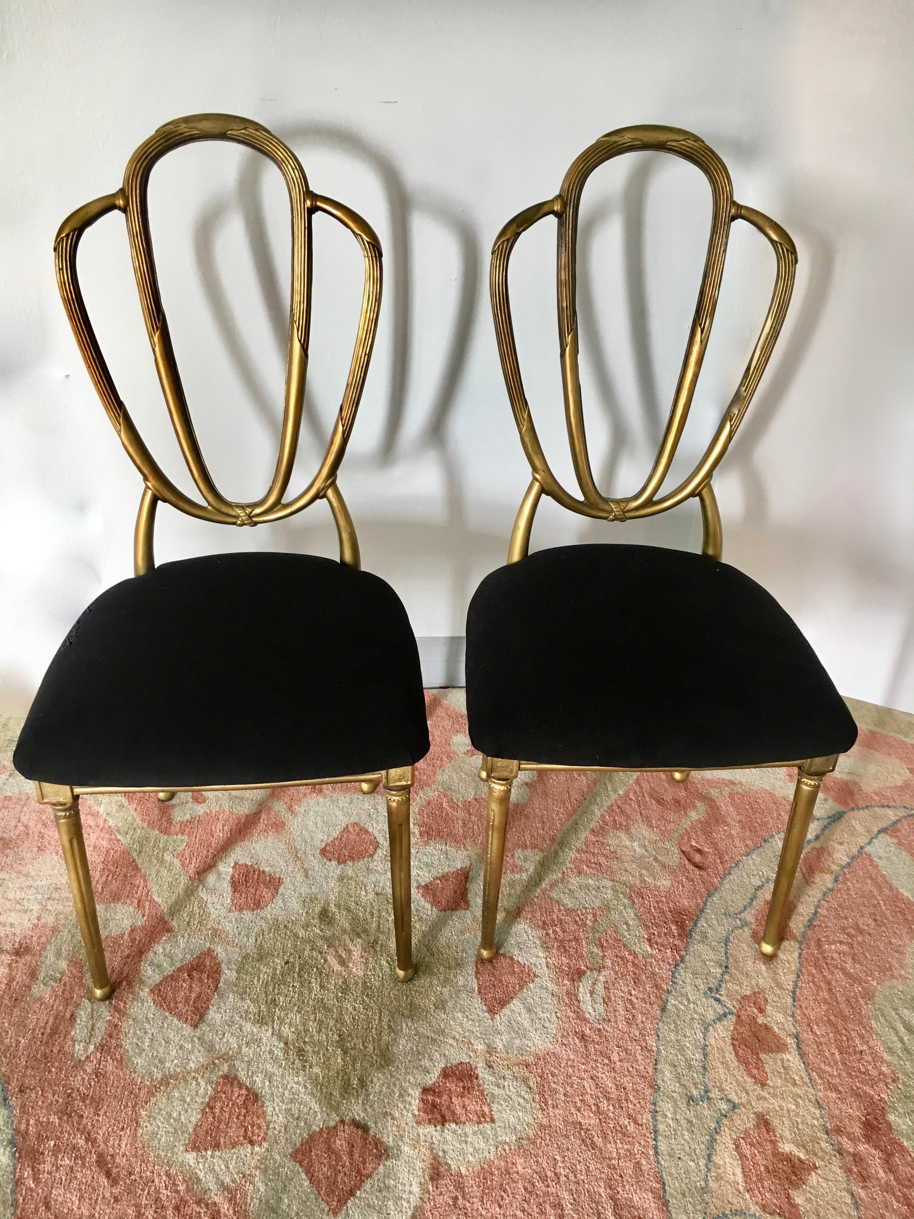 Four midcentury gold dining chairs.