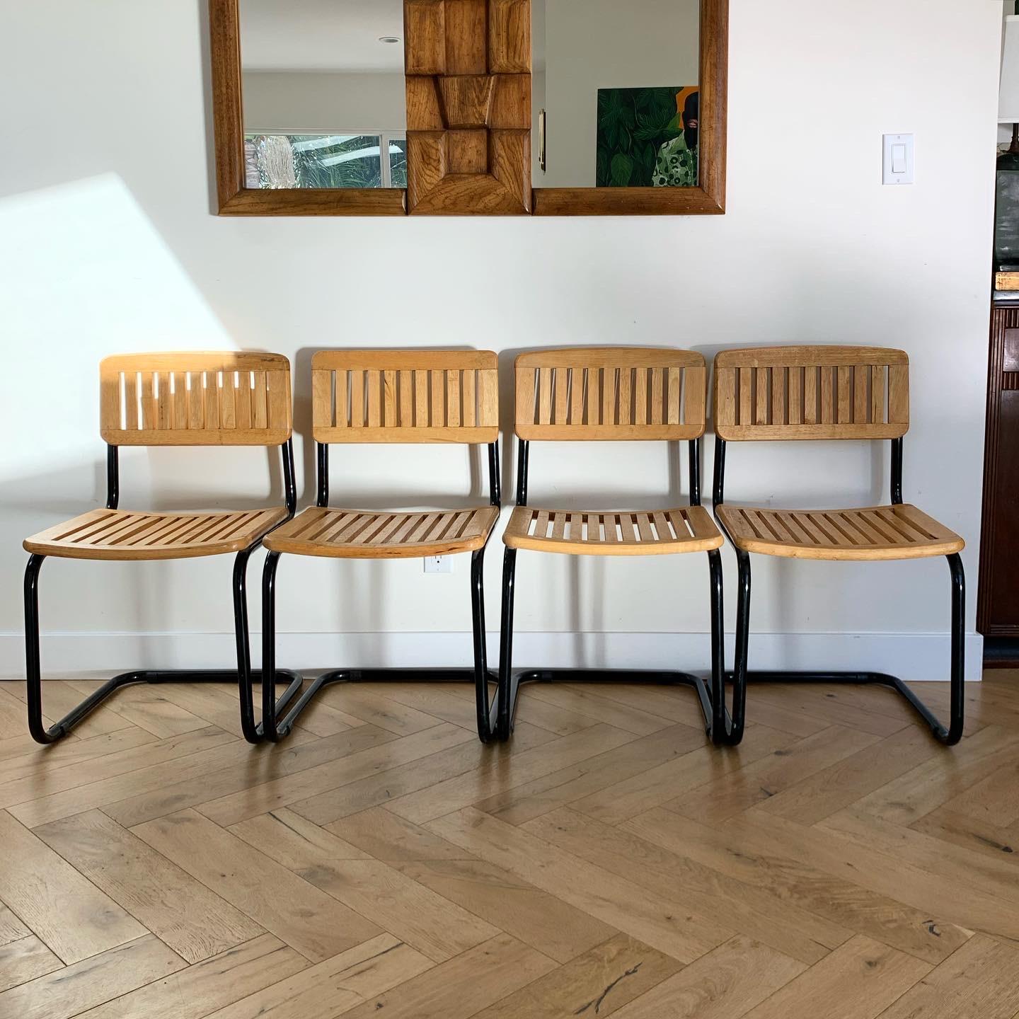 Set of 4 Mid-Century Modern unique and chic slated wood and black lacquer Cesca style chairs. Sturdy and well-made but quite light-weight. Minor moments of wear consistent with age (as shown in photos) but overall fabulous condition.

Measures:
