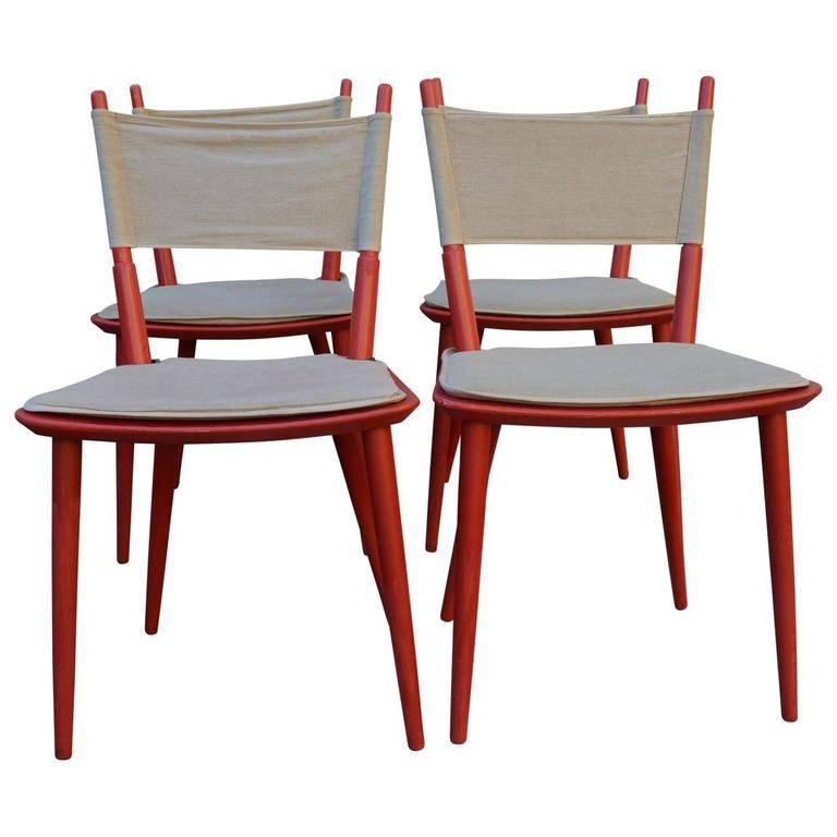 Mid-Century Modern Jorgen Baekmark dining chairs, set of four. These chairs are rare and are the original model J108 side chair, designed in the 1950s by Jorgen Baekmark for FDB Møbler. The chair is has a beech frame painted red with a canvas seat