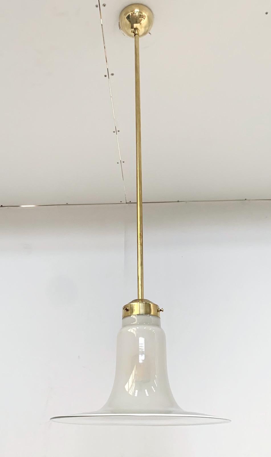 Vintage pendant with hand blown Murano glass shade in milky colored center gradually fading into clear colored edge, mounted on brass hardware / Made in Italy, circa 1960s
1 light / E26 or E27 type / Max 60W
Total Height: 42.5 inches with rod and