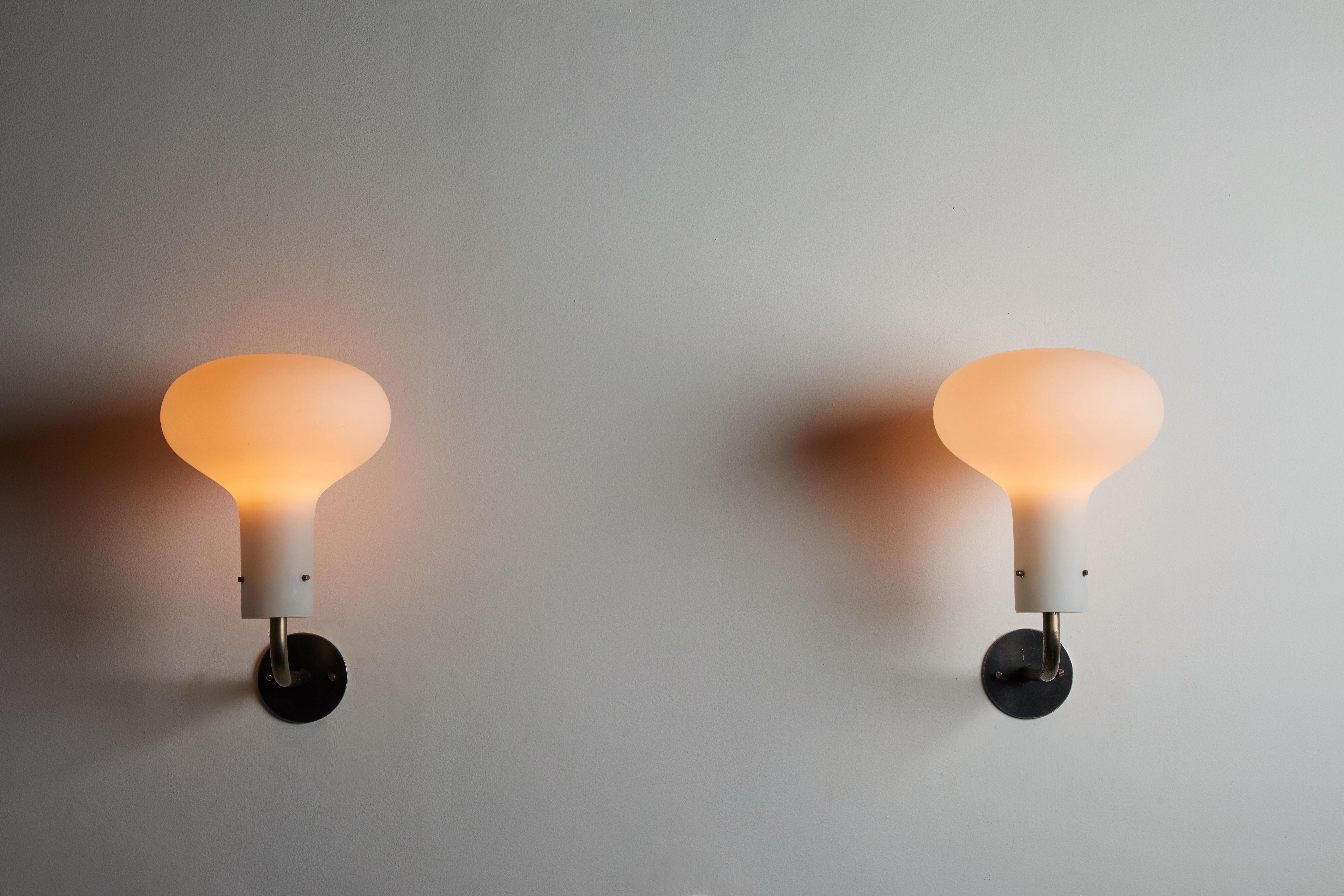 Two Model Lp12 Galleria sconces by Ignazio Gardella for Azucena. Designed and manufactured in Italy, 1958. Brushed satin glass diffusers with patinated brass hardware. Each light takes one E27 100w maximum bulb. Retains original manufacturers stamp.