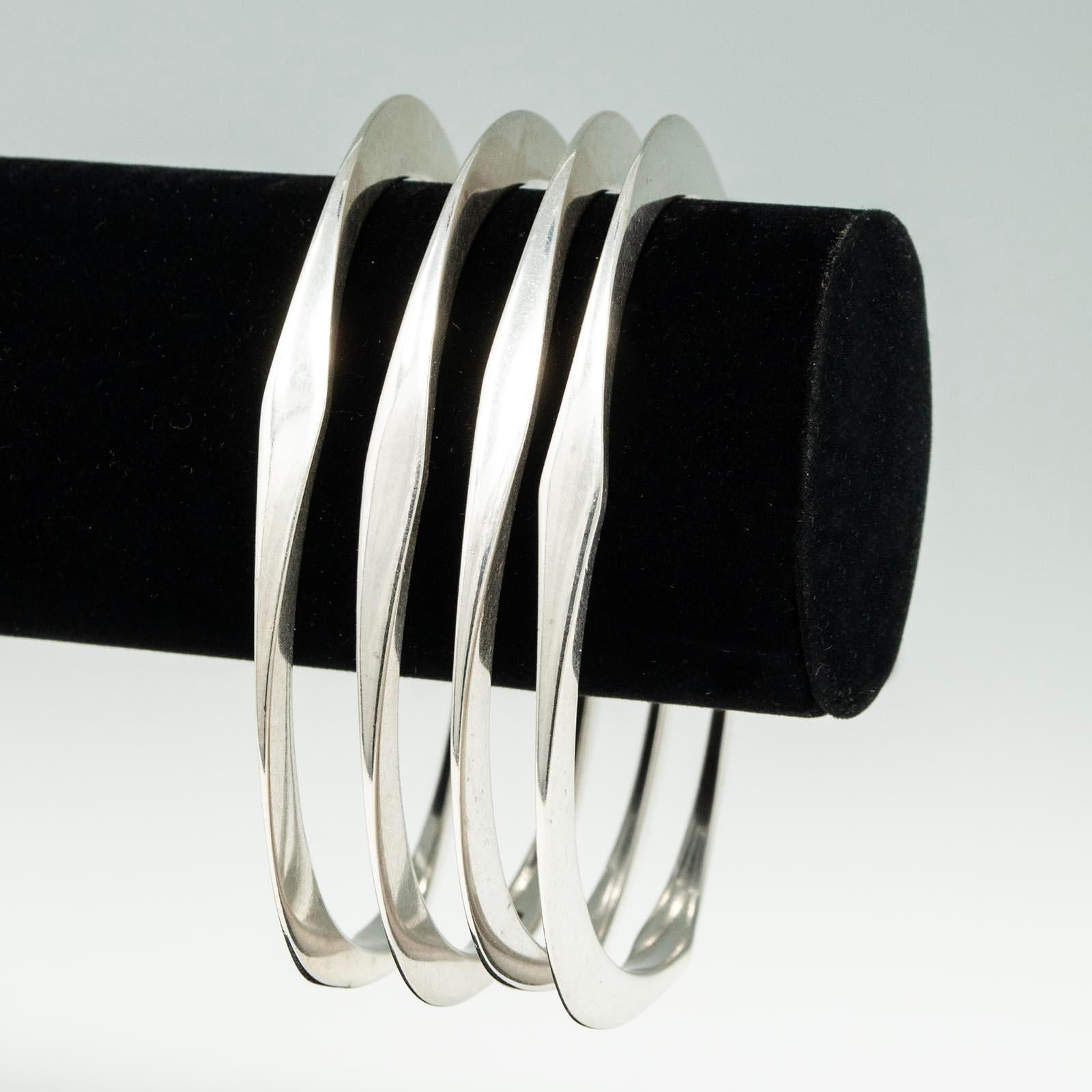 Four Modern Silver Triangular Bangle Bracelets

These handmade silver bangles have a rounded triangular shape and are marked 925.
The interior diameter is 2-5/8 inches and they weigh 20 grams each.



