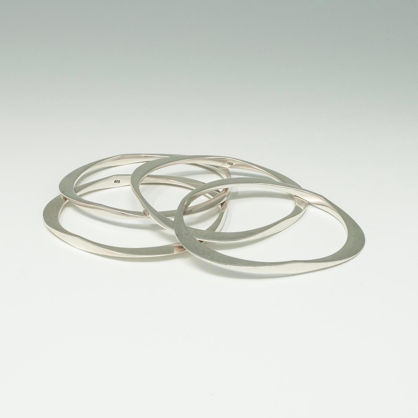Artisan Four Modern Silver Triangular Bangle Bracelets For Sale