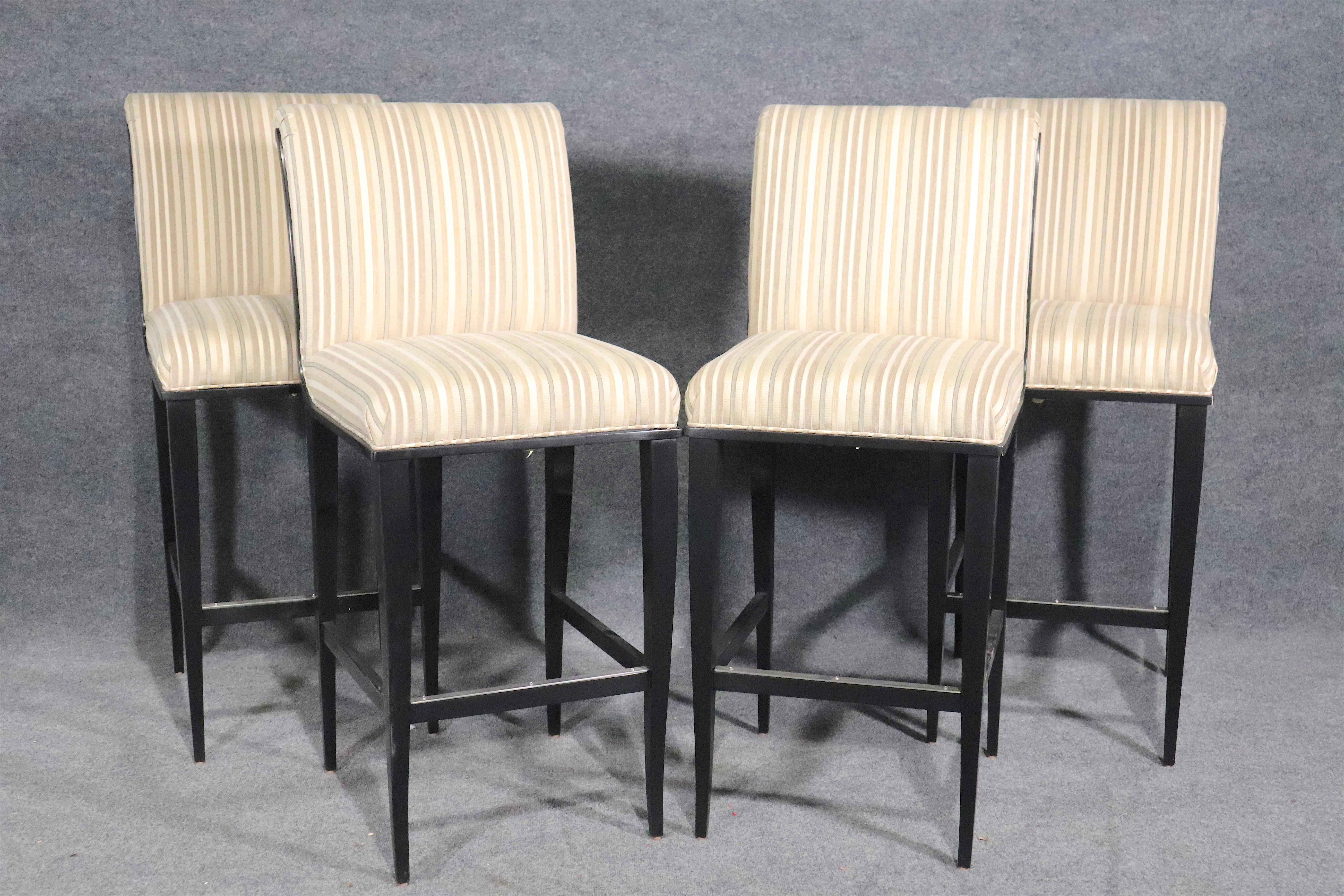 Set of four slipper style seat stools set on black frames with metal footrest.
Please confirm location.