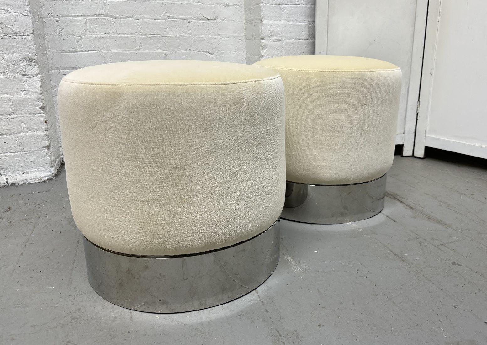 Four modern upholstered and polished chrome stools. 