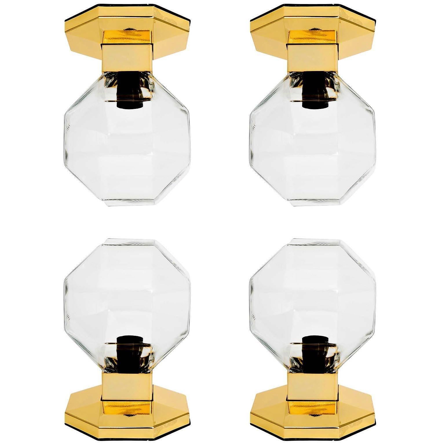 A set of four very nice table, wall, or ceiling lamps designed by Motoko Ishii for Staff Leuchten, Germany, manufactured in midcentury, circa 1970.
They are made of brass-plated finish with clear glasses. These lights can be used as sconces, flush