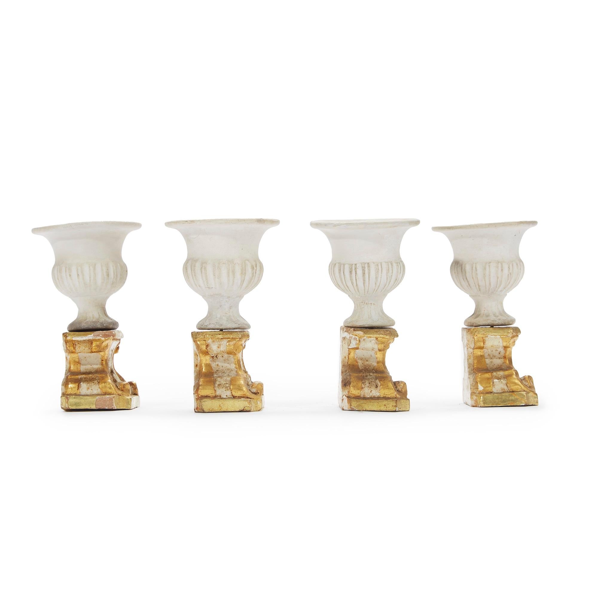 Four neoclassical biscuit and giltwood table decorations a set of four lovely small antique biscuit porcelain craters on giltwood basements with acanthus leaves and scroll carving ornaments.

The four neoclassical artworks come from a private