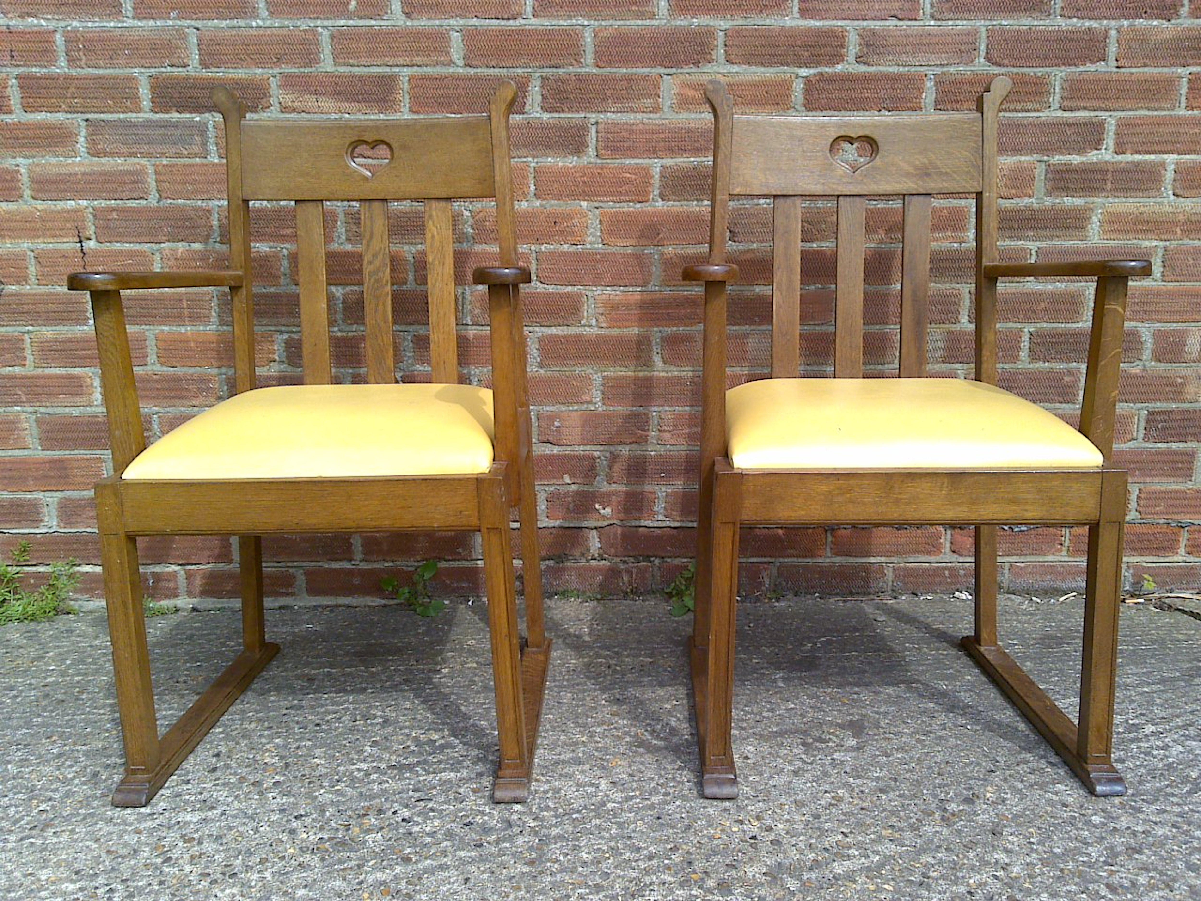 Arts and Crafts Pair Oak Armchairs, in the style of Liberty & Co with heart Cut-Out to the backs For Sale