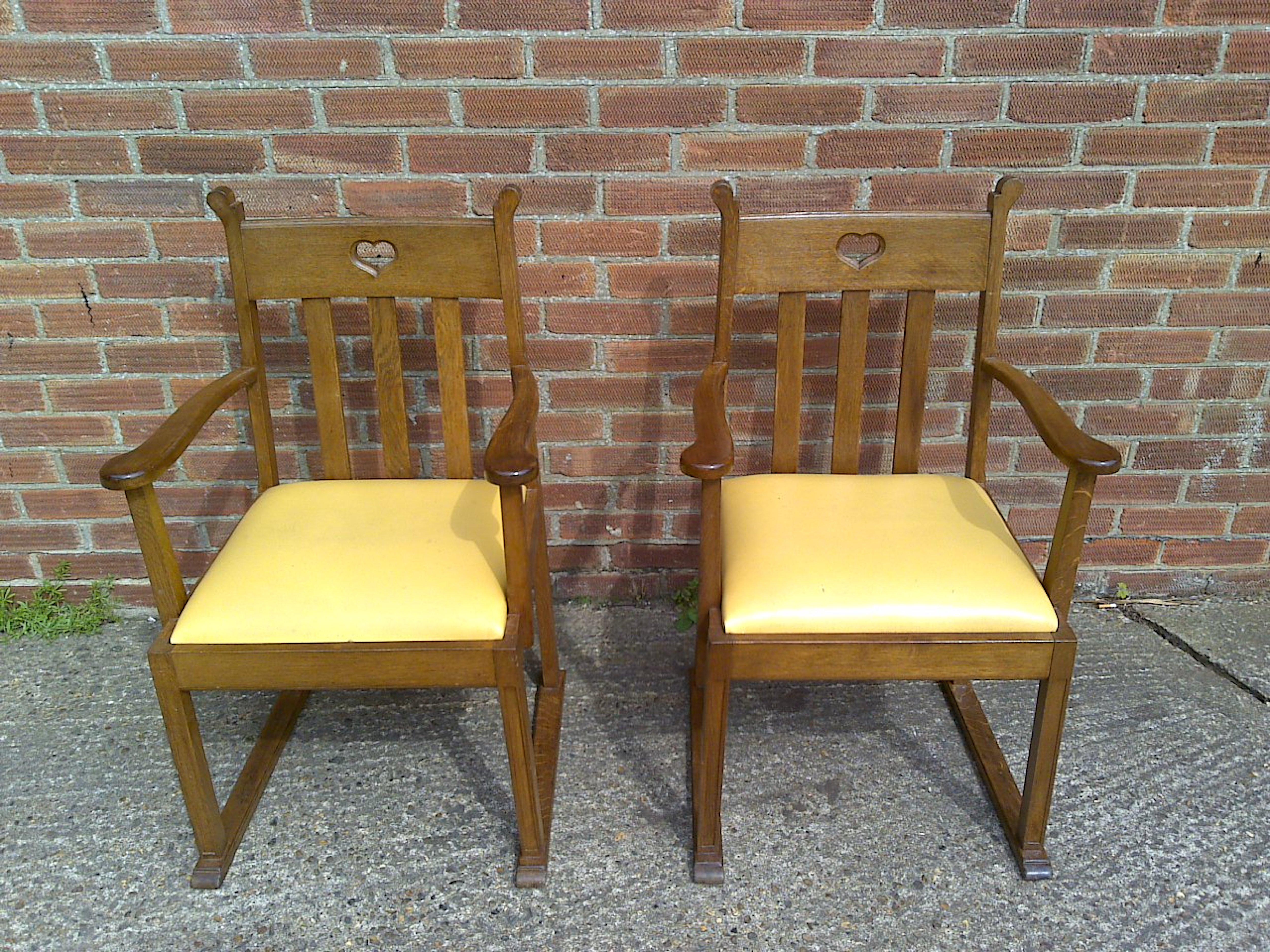English Pair Oak Armchairs, in the style of Liberty & Co with heart Cut-Out to the backs For Sale