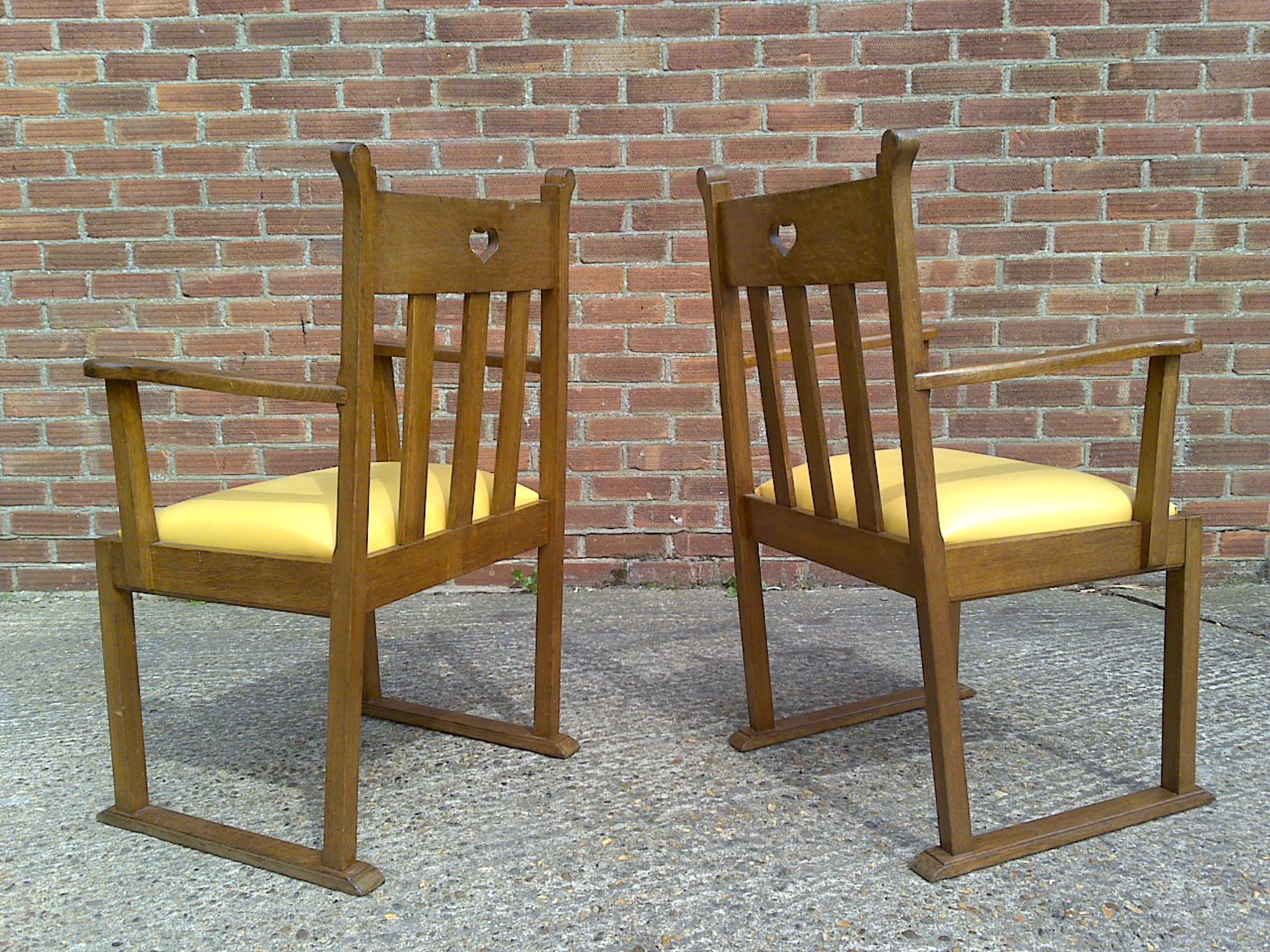 20th Century Pair Oak Armchairs, in the style of Liberty & Co with heart Cut-Out to the backs For Sale