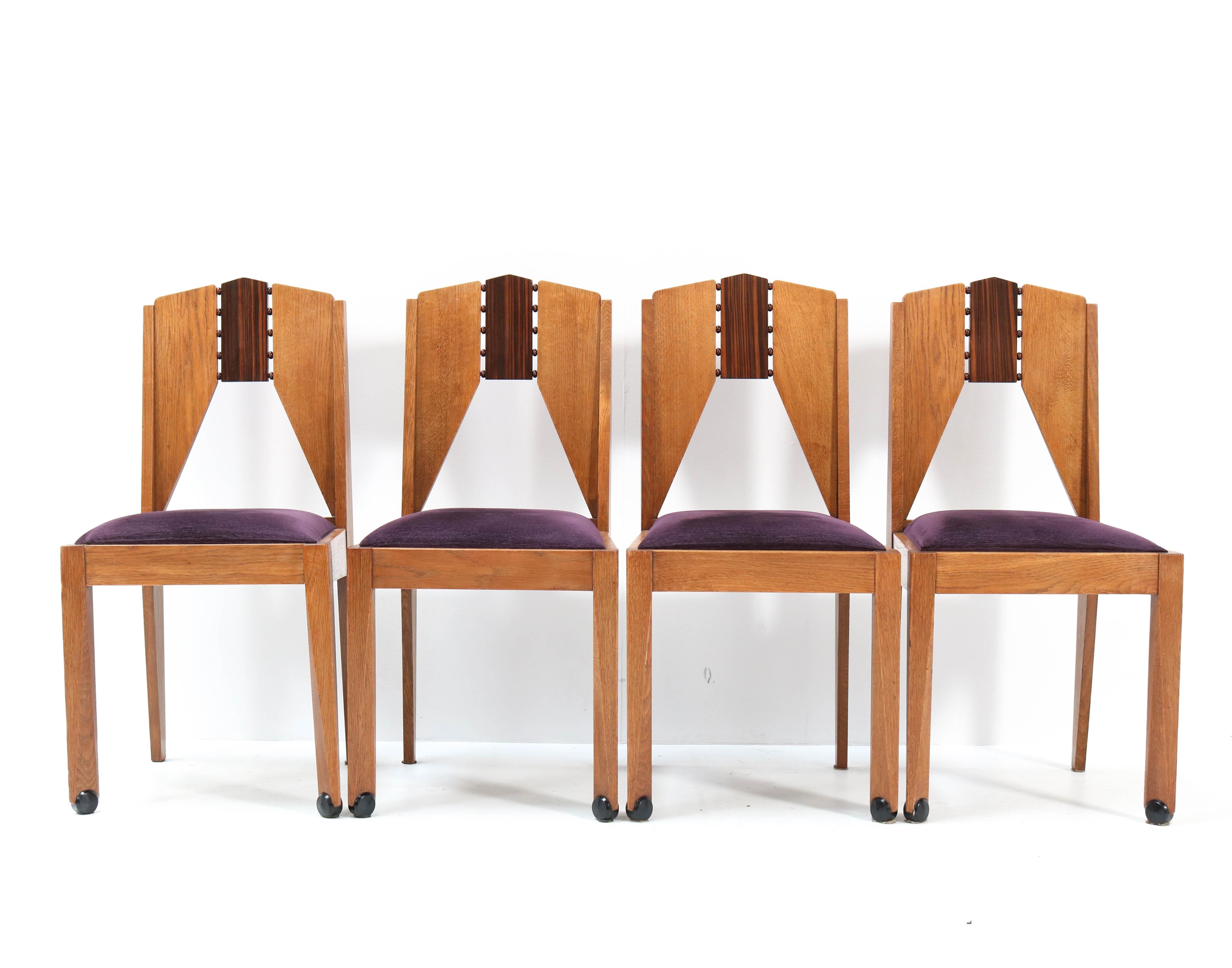 Wonderful set of four Art Deco Amsterdamse School chairs.
Design by J.J. Zijfers Amsterdam.
Striking Dutch design from the 1920s.
Soild oak and solid macassar ebony and macassar ebony veneer.
Re-upholstered with purple velvet fabric.
In very