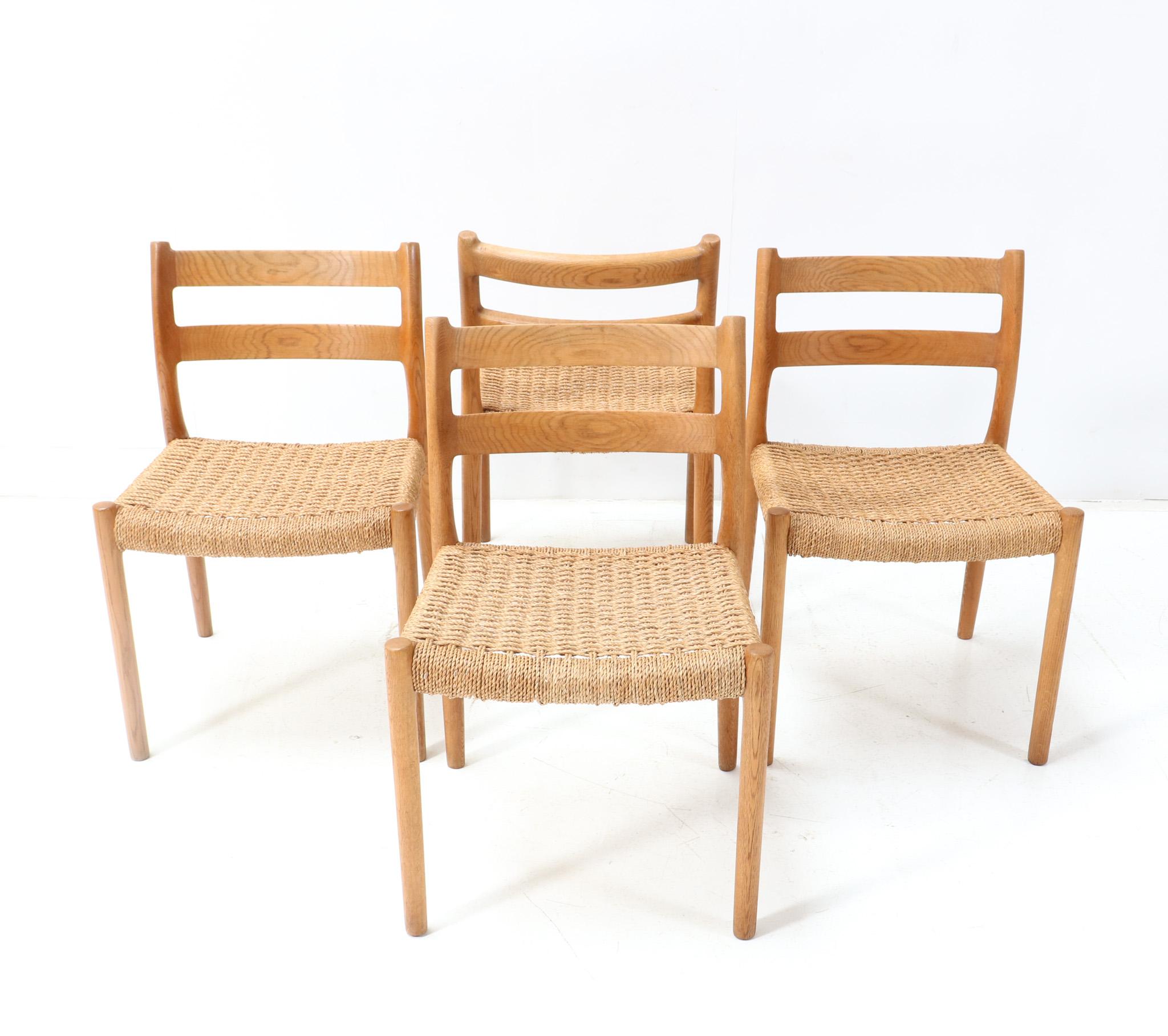 Stunning set of four Mid-Century Modern Model 84 dining room chairs.
Design by Niels Otto Møller for J.L. Møllers Møbelfabrik.
Striking Danish design from the 1970s.
Elegant shaped solid oak frames with original papercord seats.
Marked with original