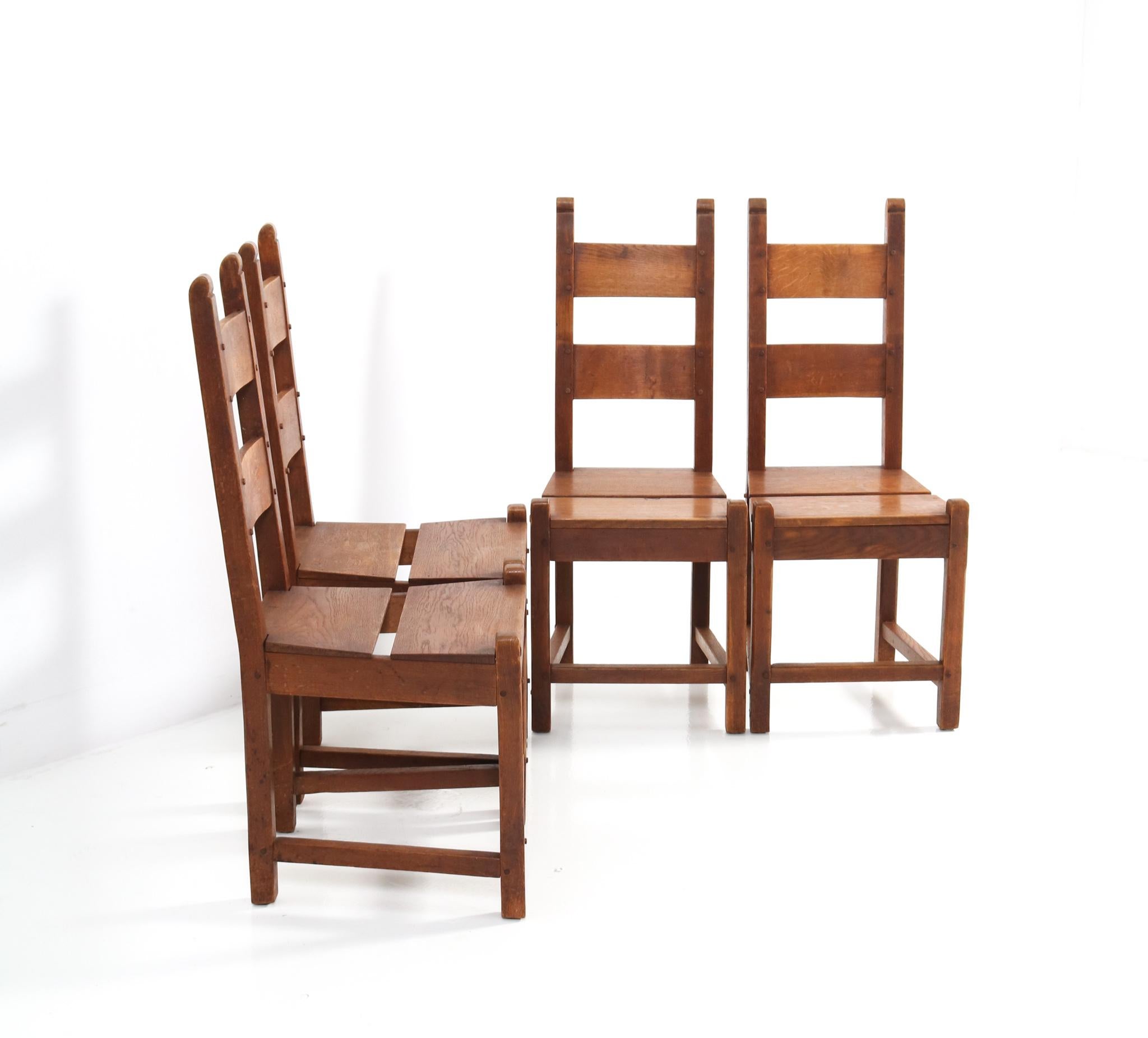Stunning and rare Rustic Brutalist set of four dining room chairs.
Striking Dutch design from the 1940s.
Solid oak with original split seats.
In very good condition with a beautiful patina.
