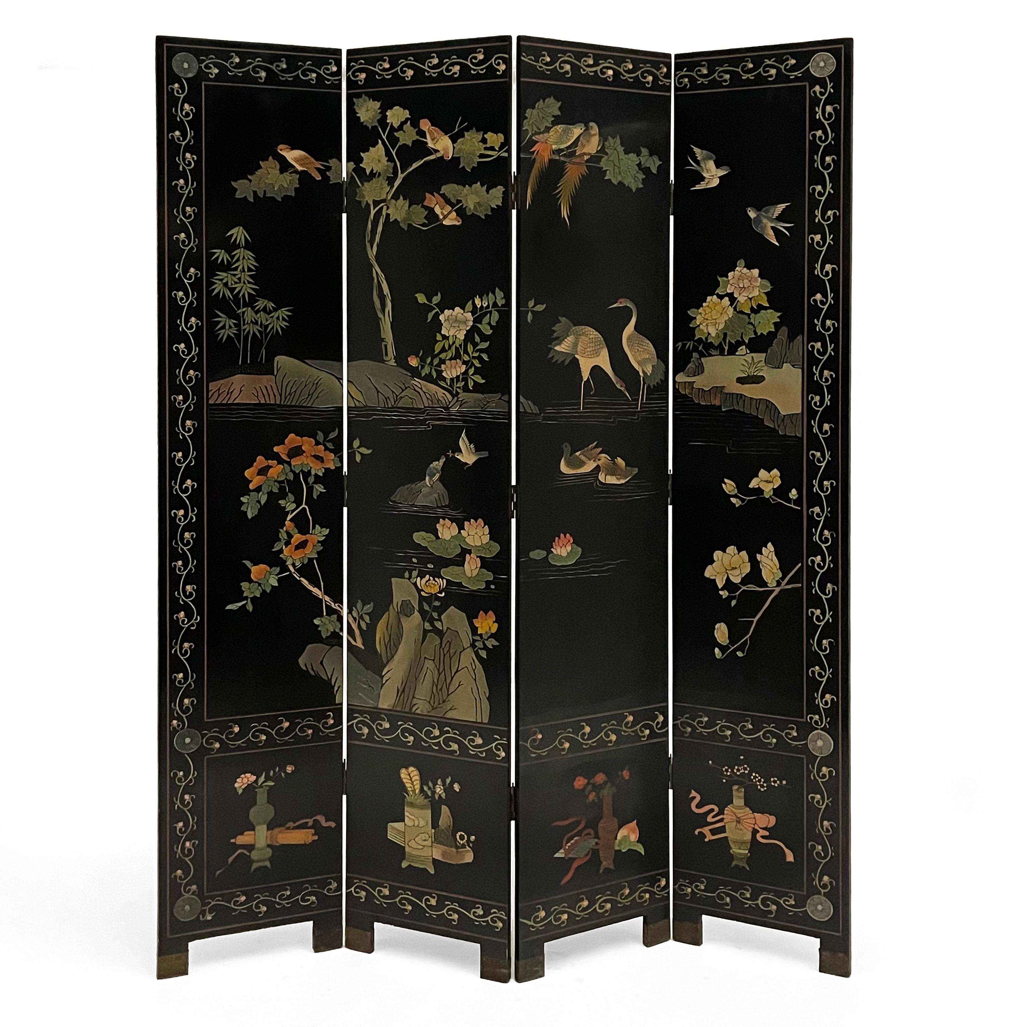 This screen has four panels with brass feet. The front features a tranquil nature scene with a variety of birds bordered by a pattern flowering vine with four different antique vases with flowers at the bottom, while the back shows two white cranes