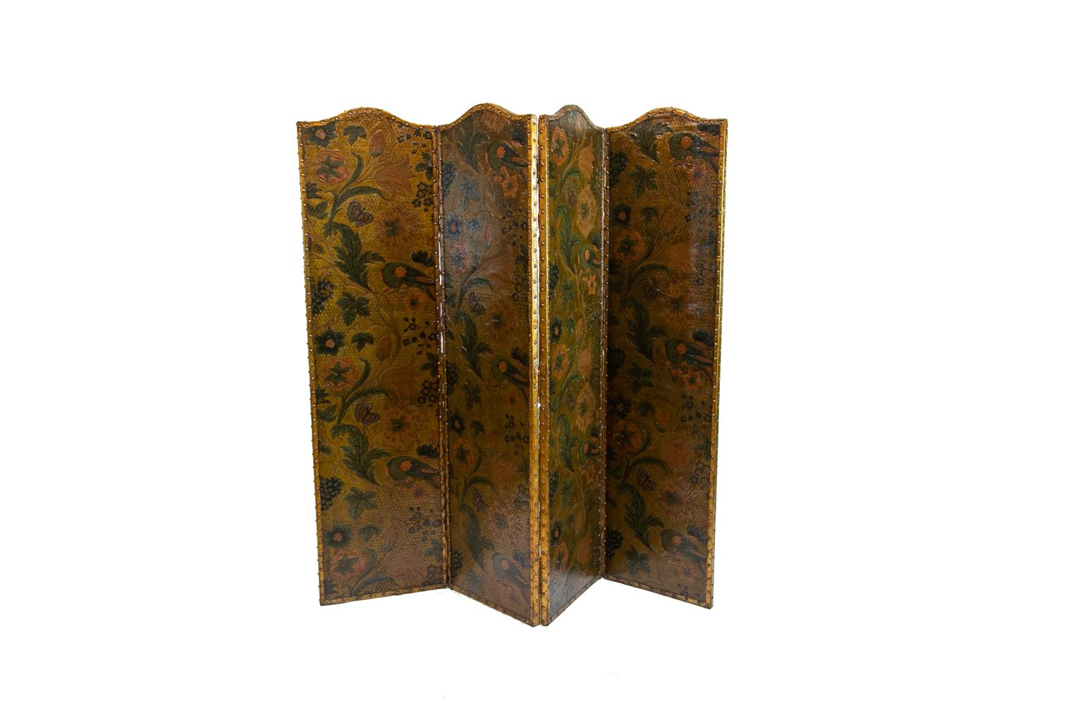 Four panel embossed leather screen, with embossed leather edging attached with brass studs. The decoration is floral with birds, butterflies, and grapes.

  