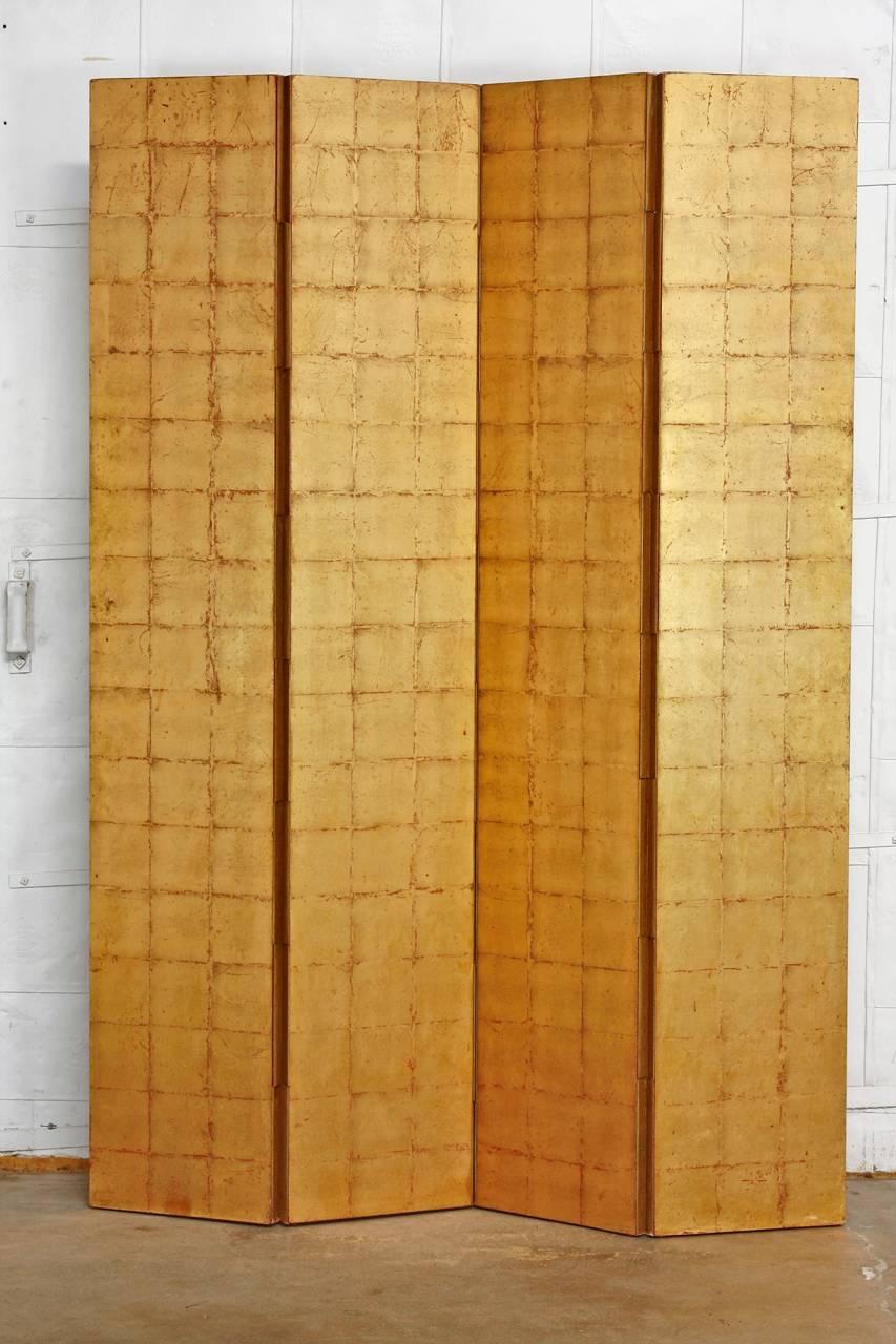 Impressive four panel gold leaf room divider screen featuring geometric squares of gold leaf on two sides. Constructed from solid wood panels that have been lacquered and then decorated with gilt. The joints are neatly concealed with canvas in a